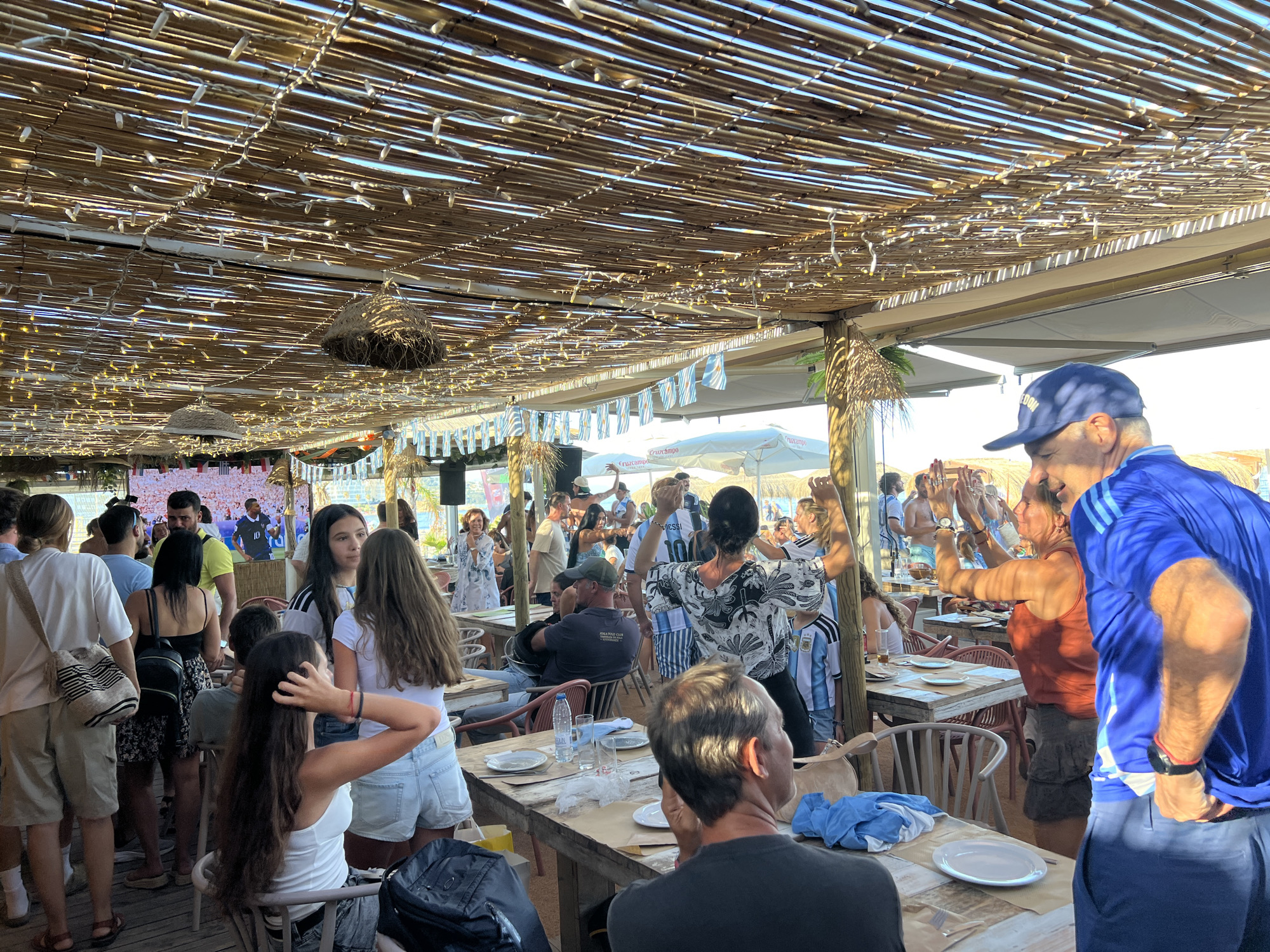 Busy outdoor bar scene at a San Roque beachside spot