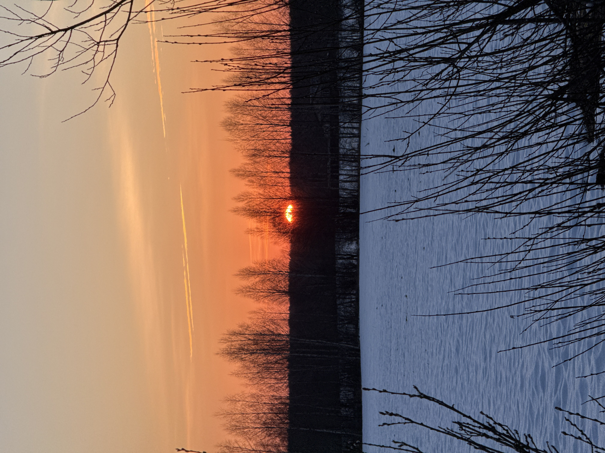 Winter sunset captured over frozen water in Bol'shie Mkhi