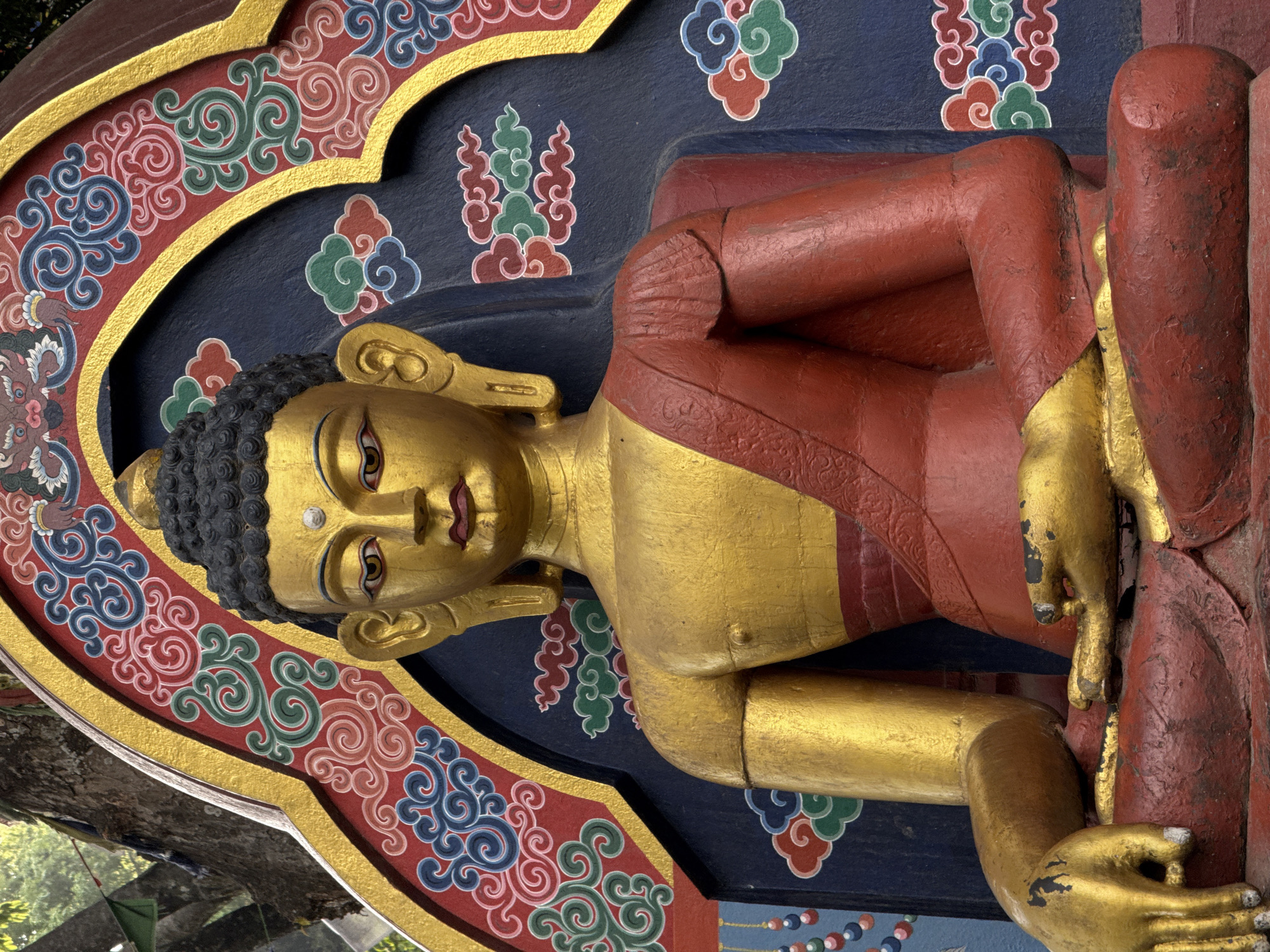 Buddhist temple visit documented in Kathmandu with statue, prayer flags