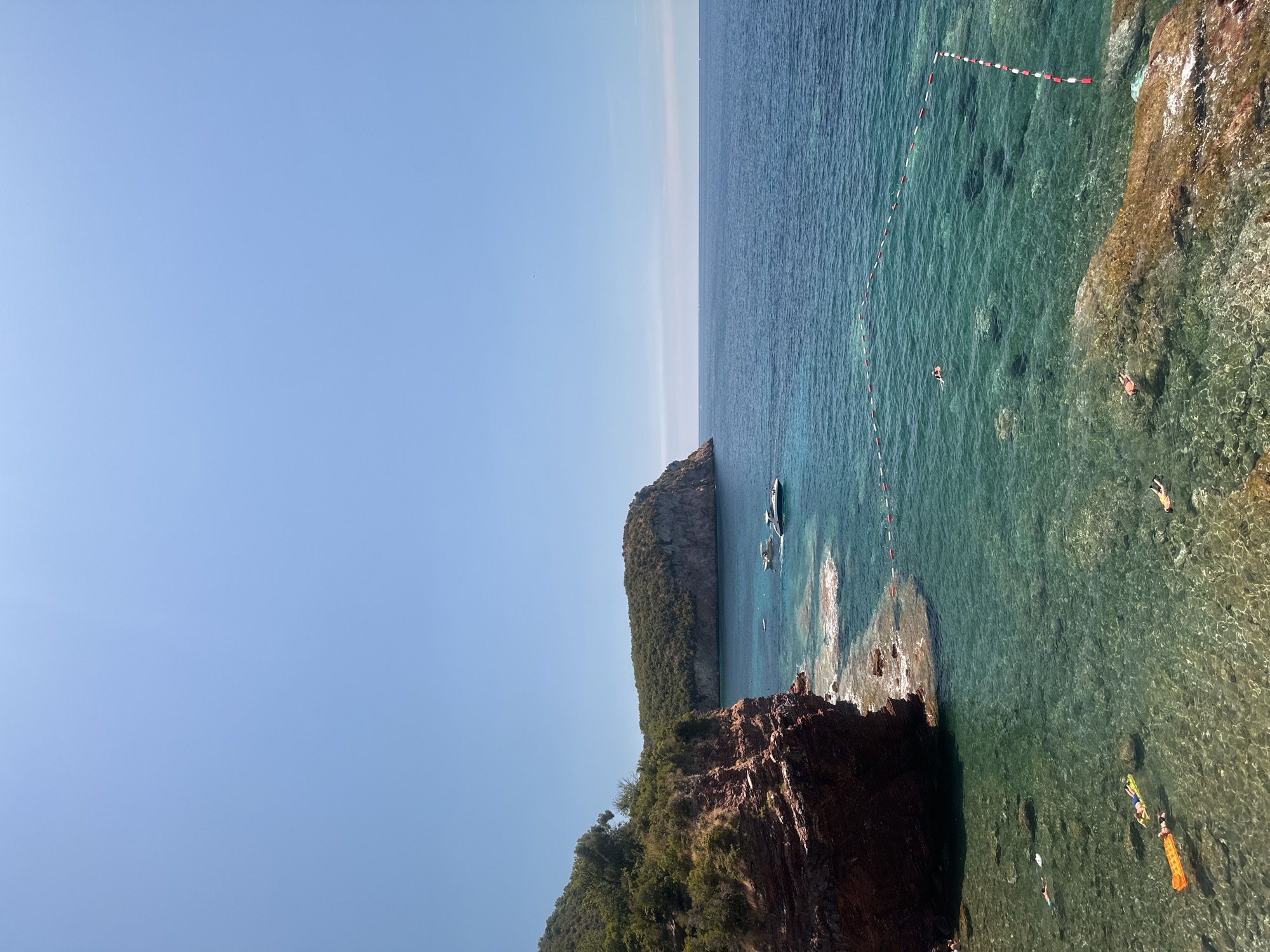 Sveti Stefan's rocky Adriatic coast on a clear summer morning