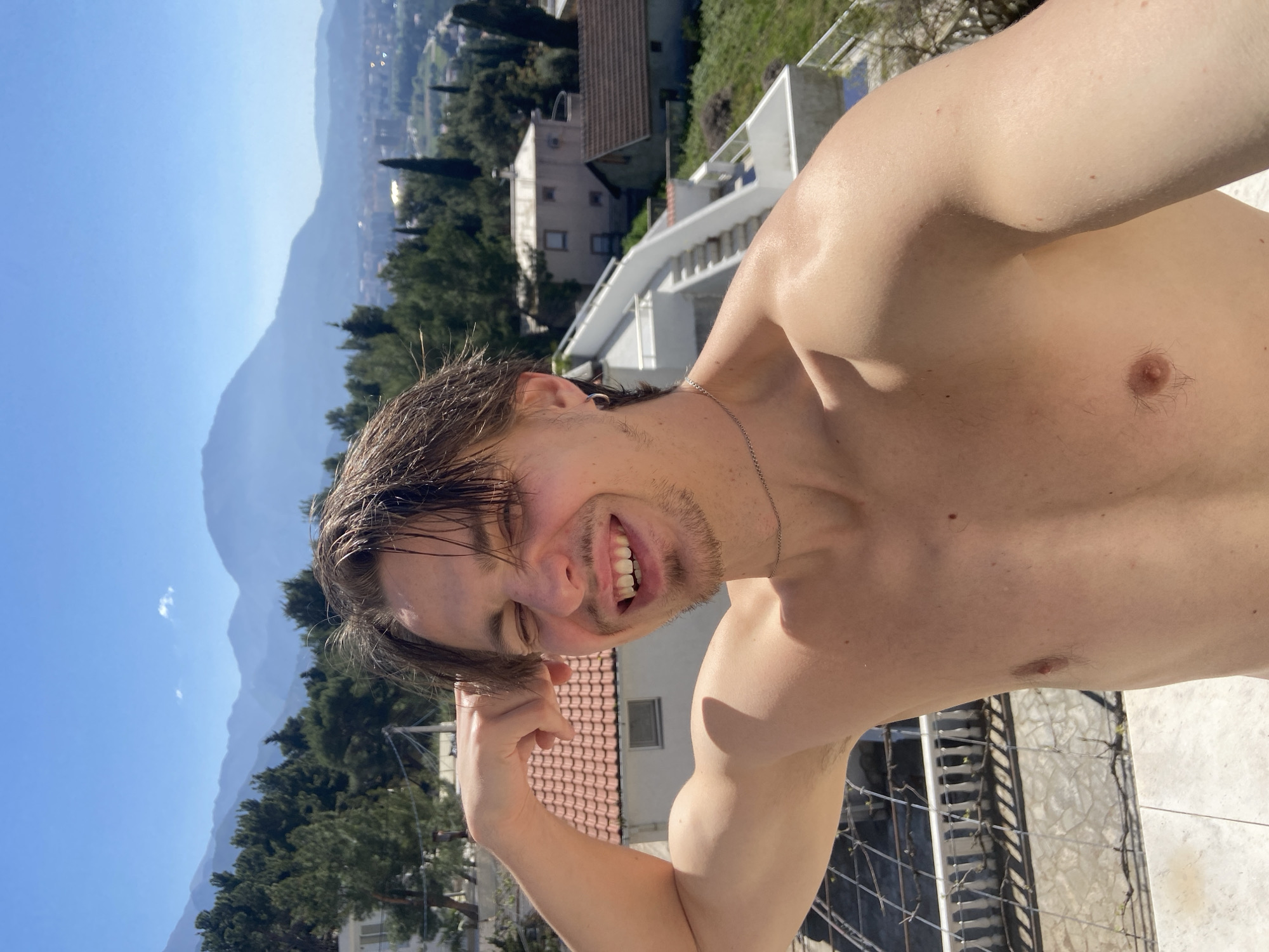 Man enjoys morning leisure moment on Montenegro coast balcony