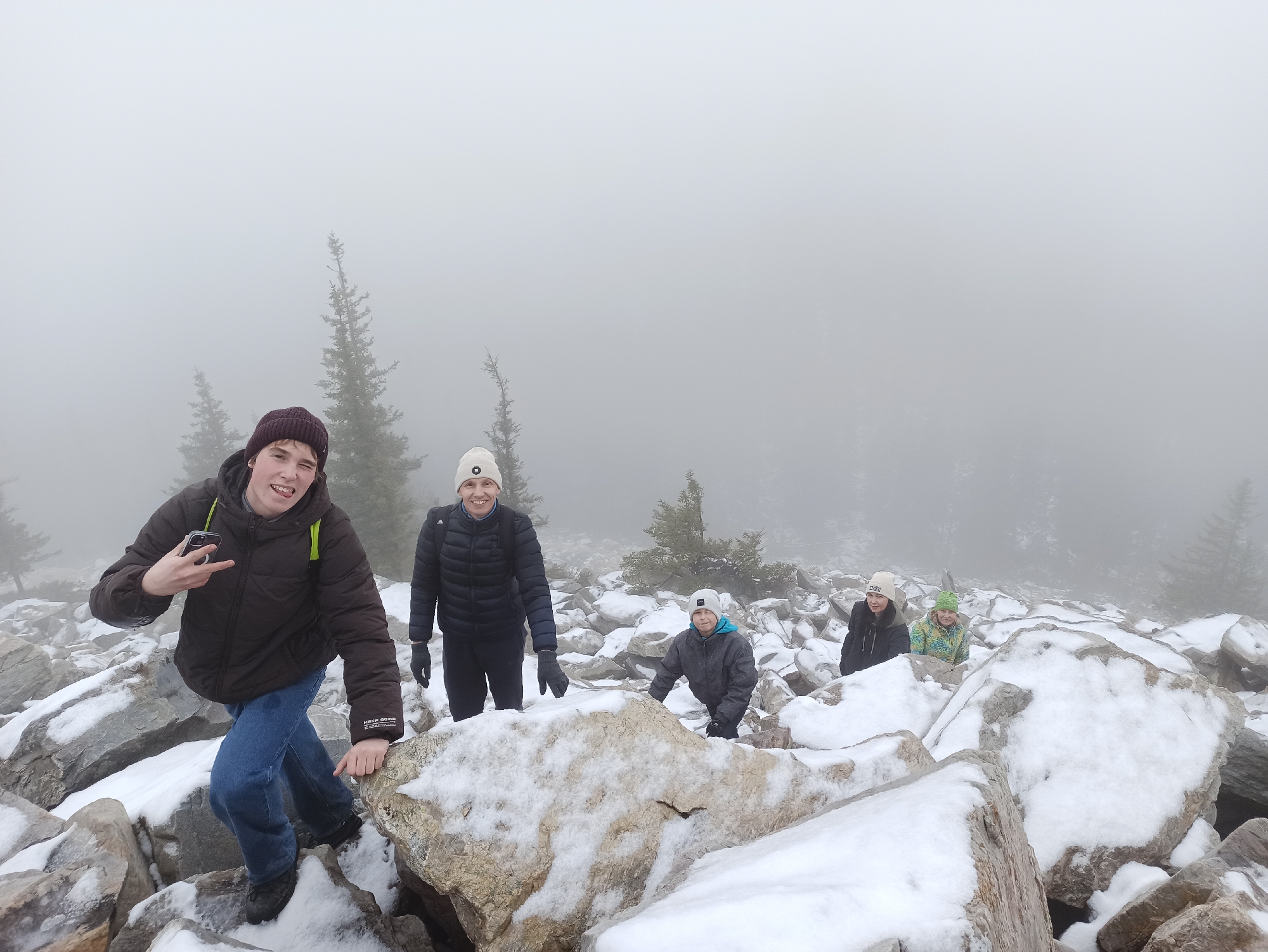 Hikers Navigate Foggy Snow-Covered Terrain Near Ziuratkul, Russia