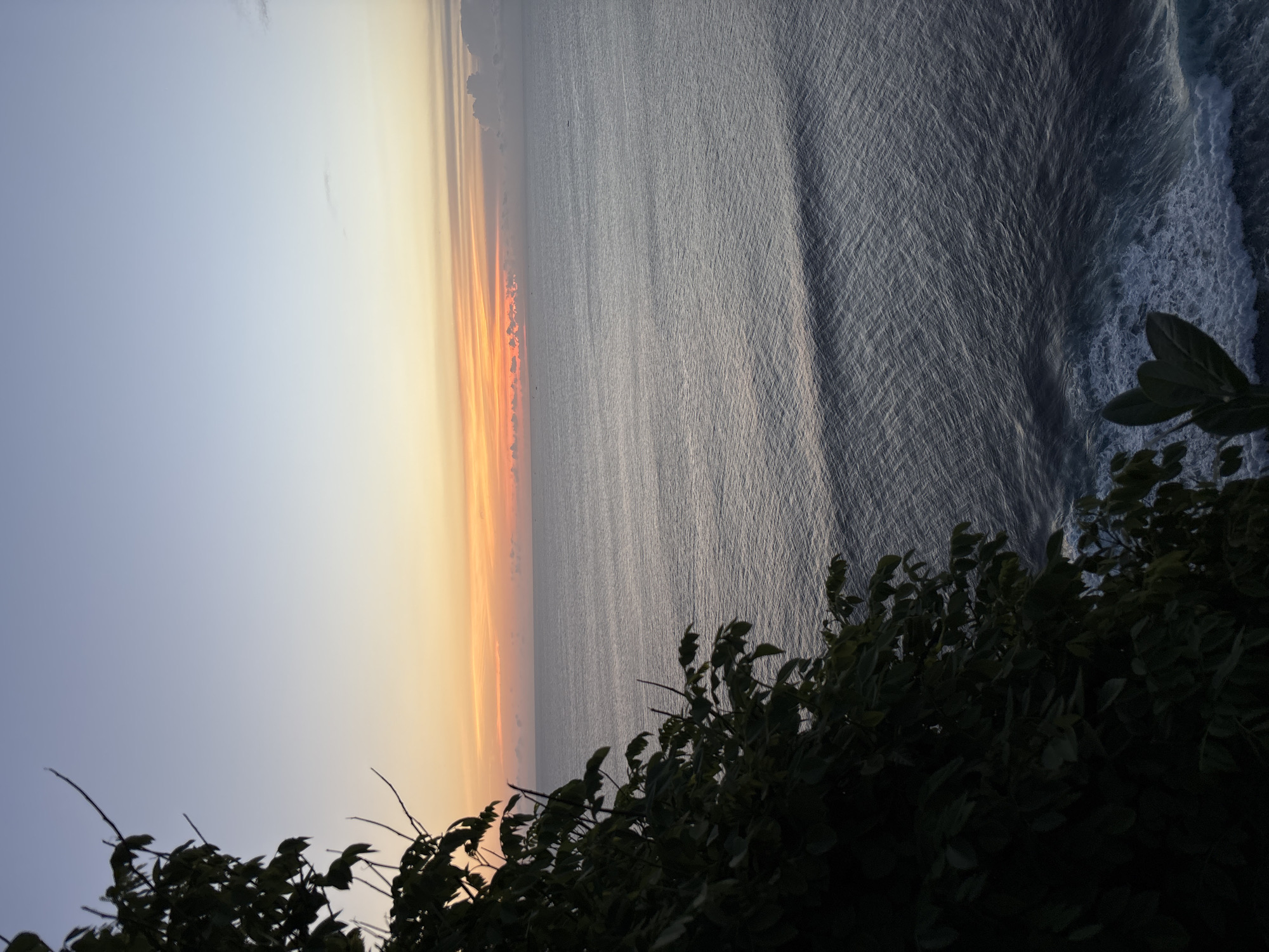 Sunset gathering observed on Pecatu cliffs overlooking ocean