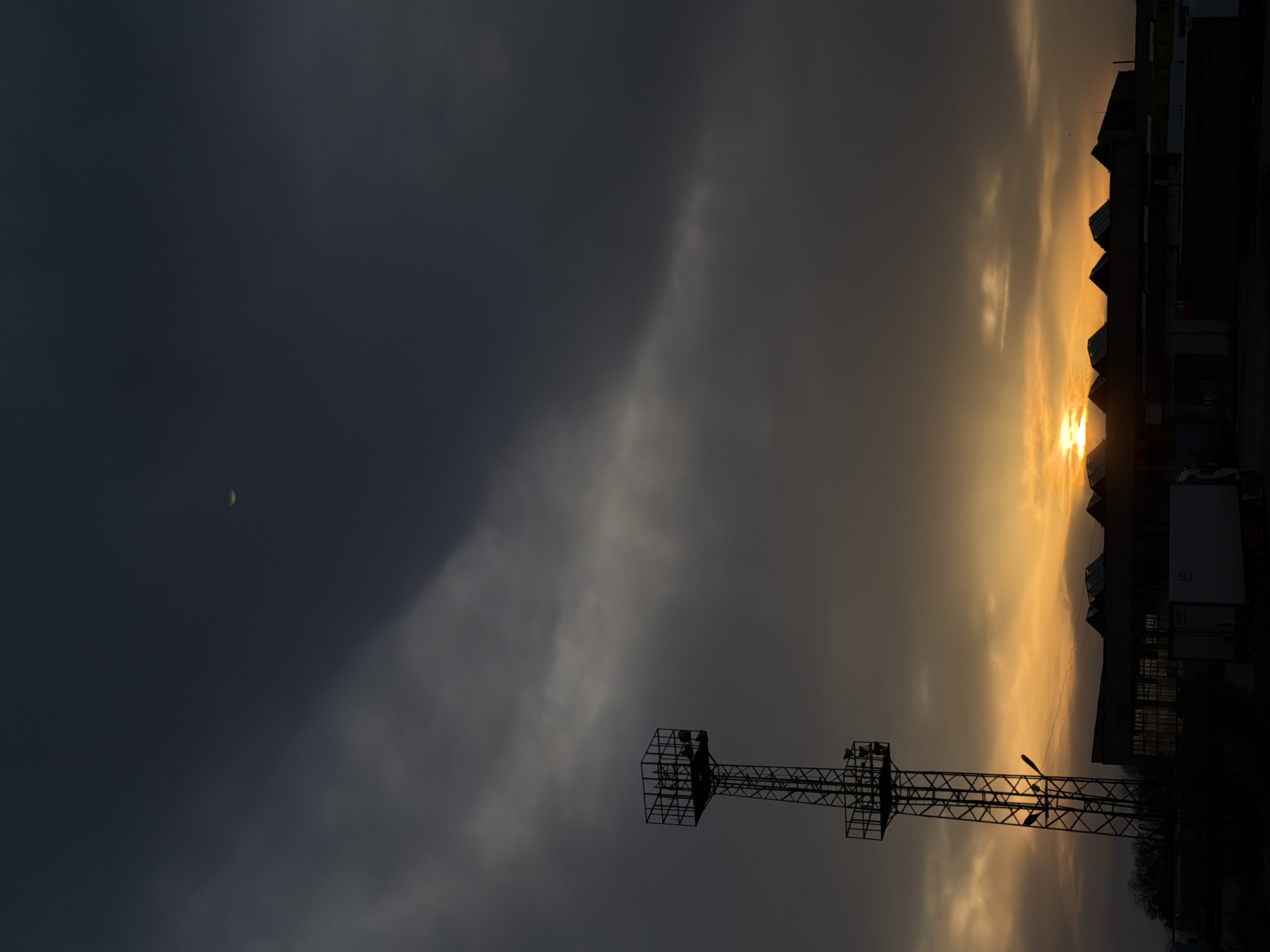 Sunset silhouettes transmission tower in Chirpan, Bulgaria