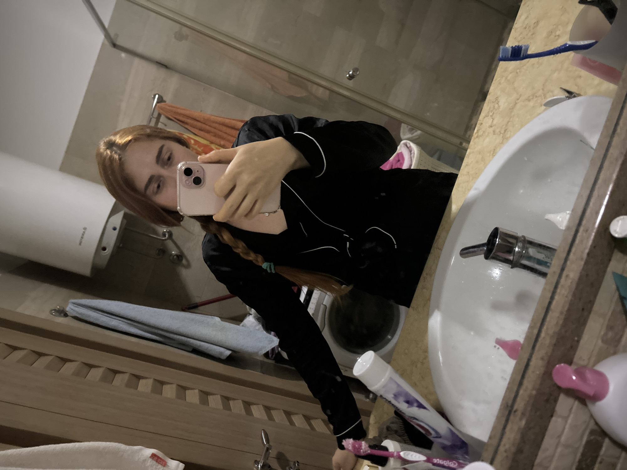 Woman documents evening routine amid cluttered kitchen in Budva apartment
