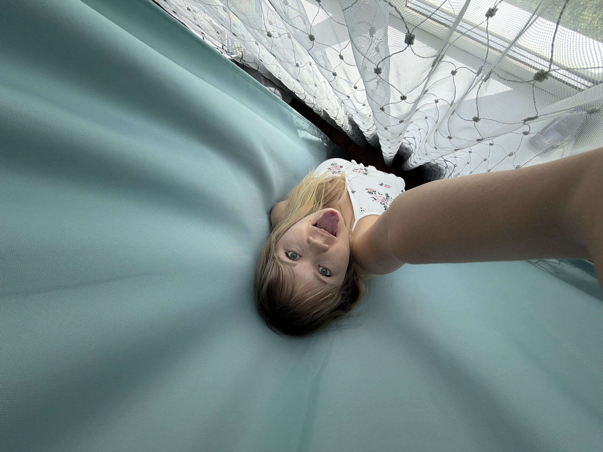 Woman takes morning selfies in bedroom in Chaikovsky, Russia
