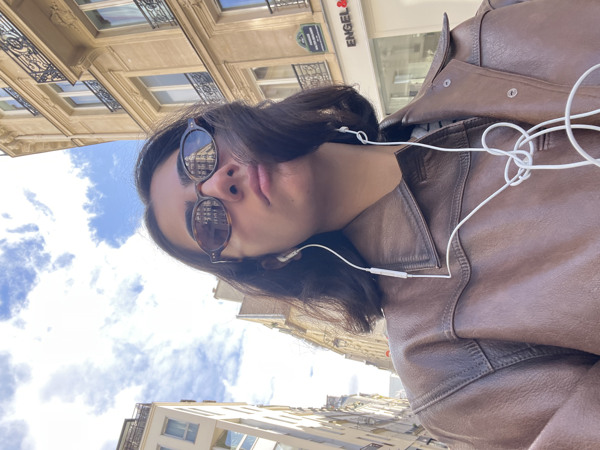 Person photographed looking skyward in Paris daylight