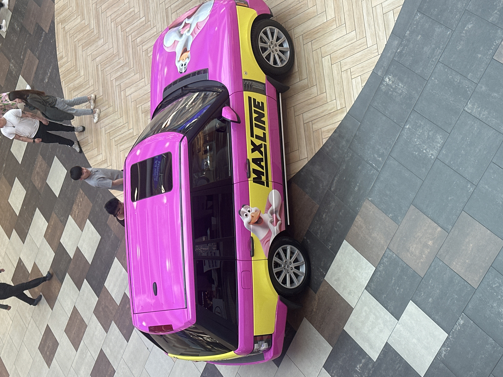 Pink Range Rover with cartoon graphics displayed in Minsk mall