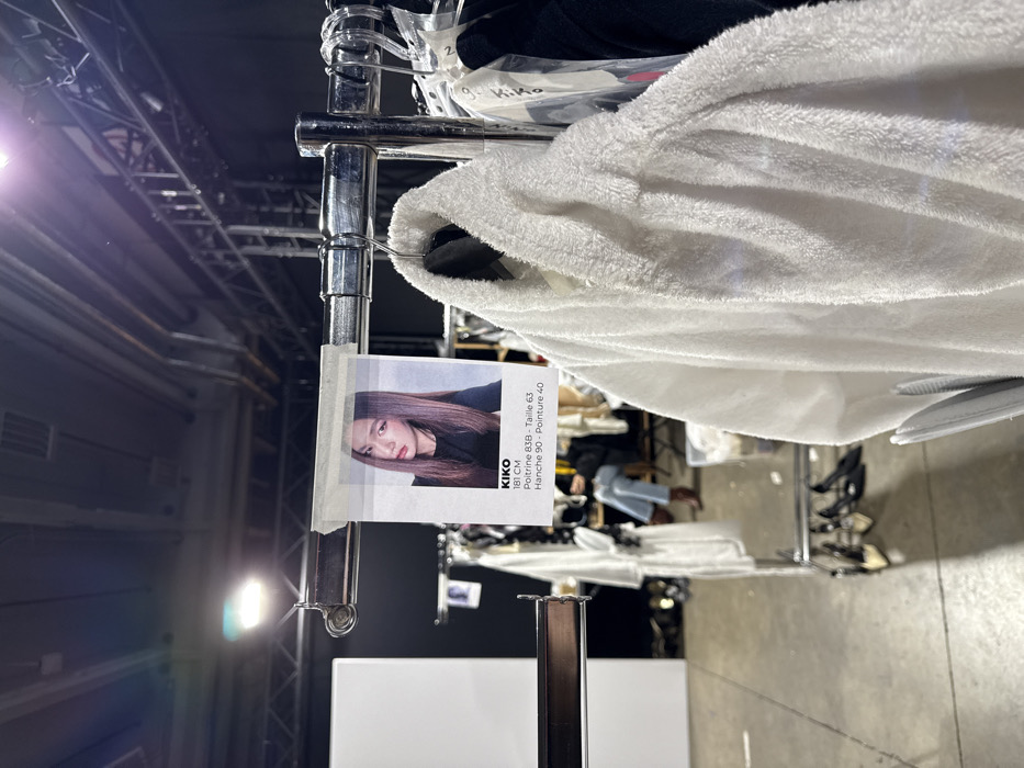 Fashion show staged in Issy-les-Moulineaux with blue-lit runway