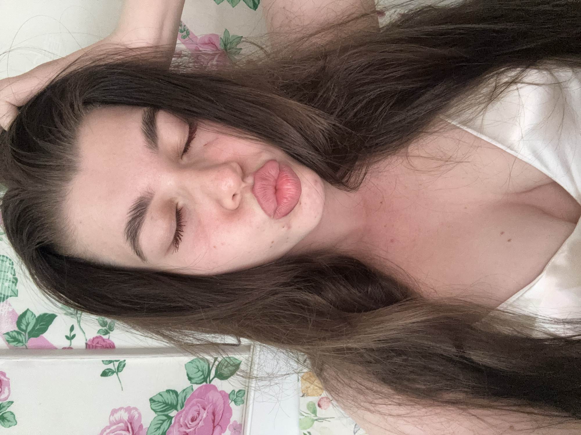 Woman resting on floral surface captured in multiple memories