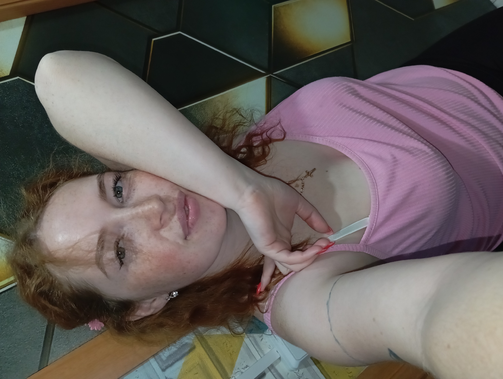 Woman poses on tiled surface in Yurgamysh