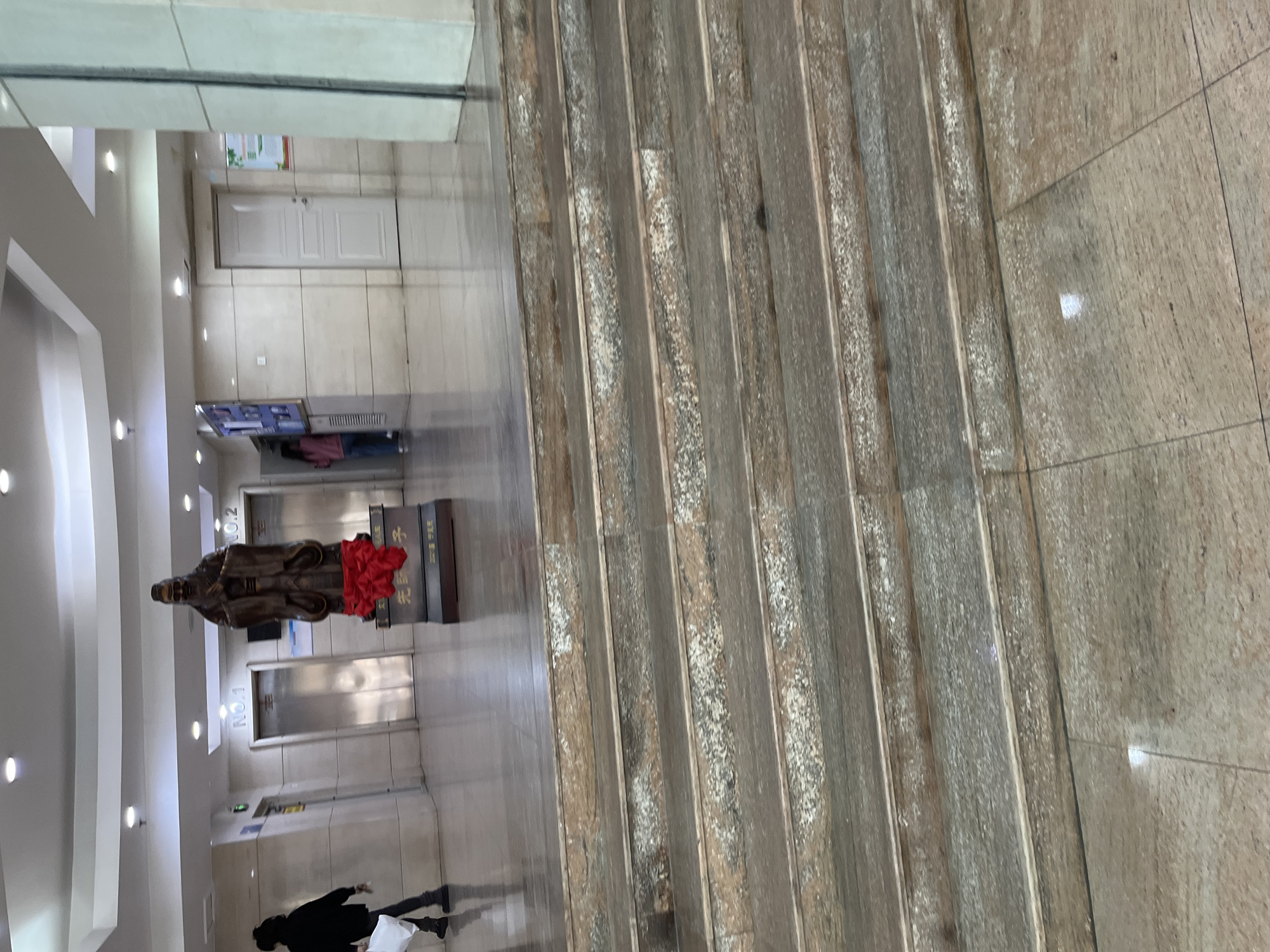 Building lobby with statue and elevators captured in Changchun