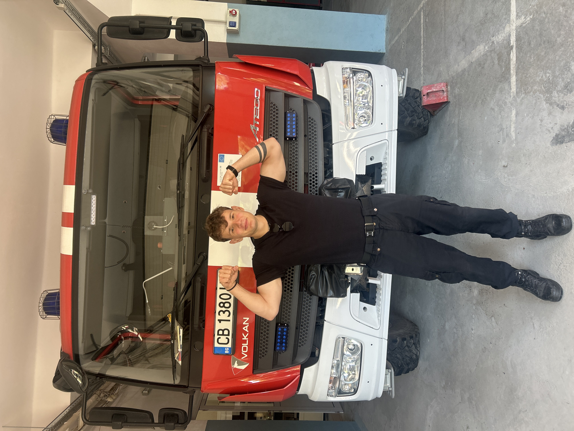 Man poses with fire truck at Sofia station