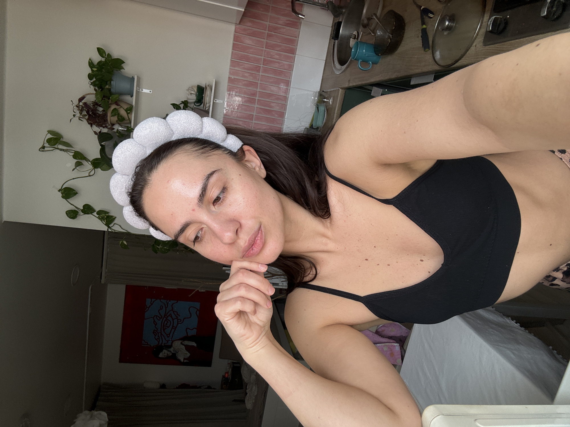 Woman in contemplative pose captured in kitchen setting
