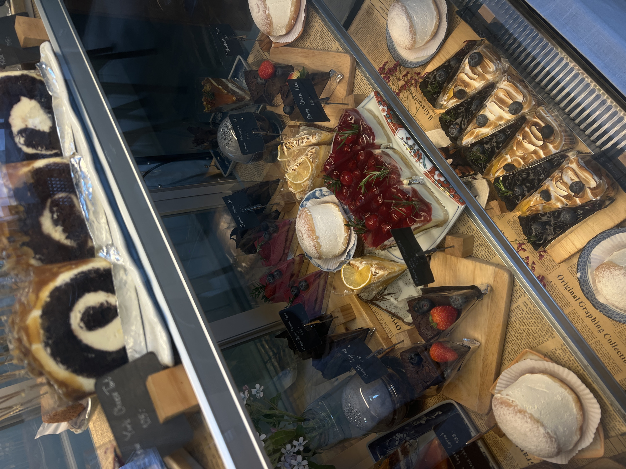 Bakery display case spotted with assorted desserts and pastries