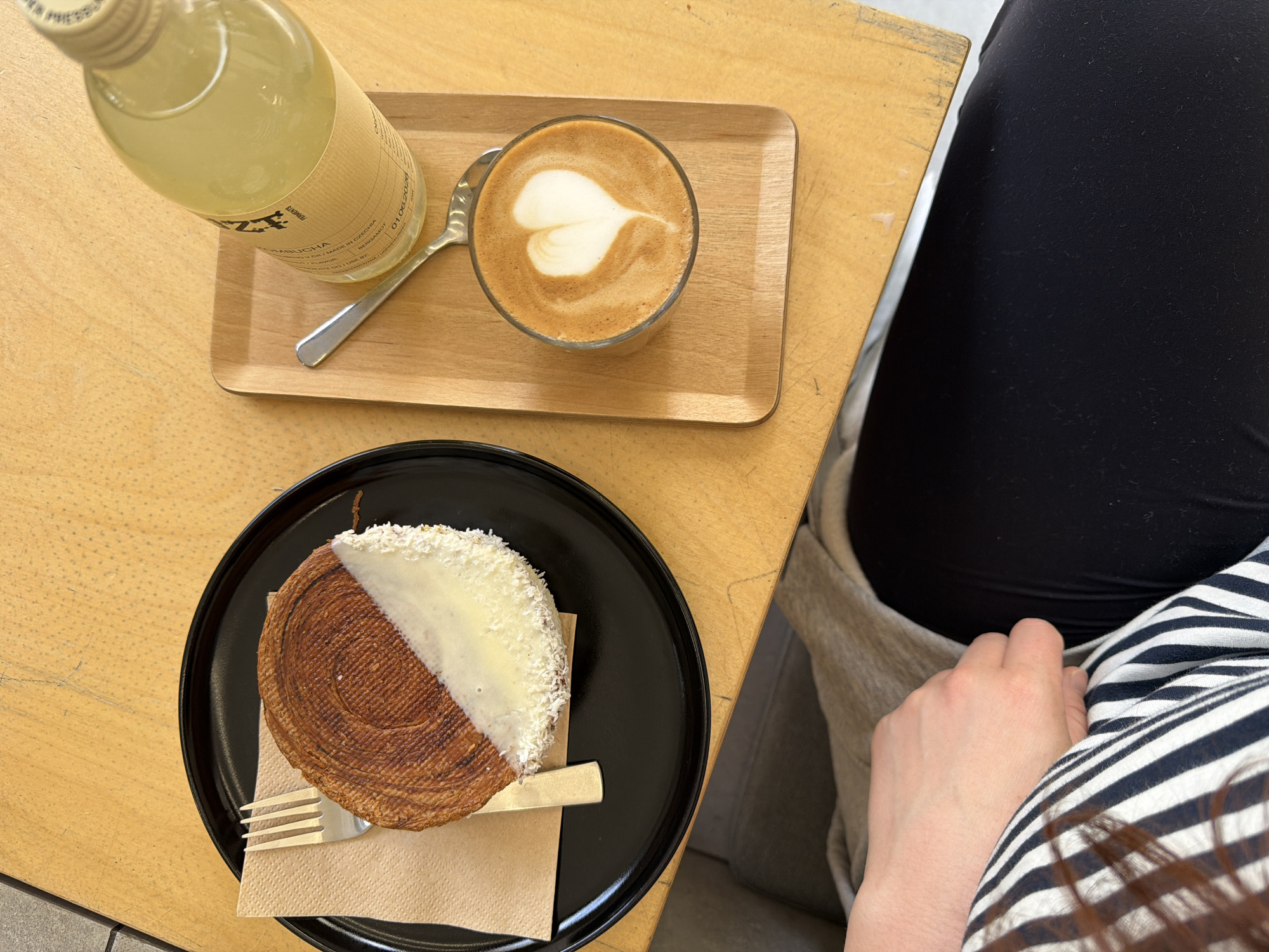 Morning cafe scene captured in Prague with kombucha and pastries