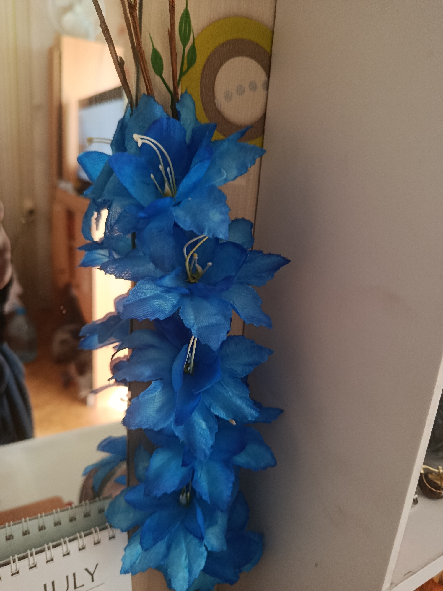 Decorative flowers and colorful abstract wall art, indoors.