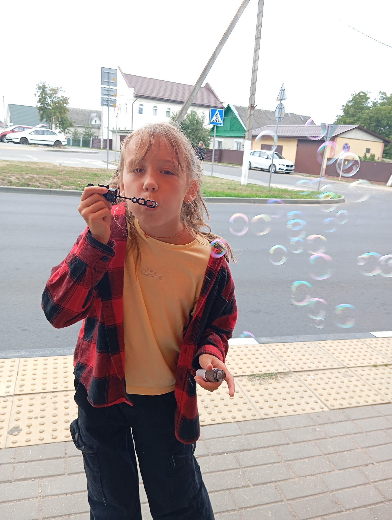 Blowing bubbles on a sidewalk, casual afternoon moment
