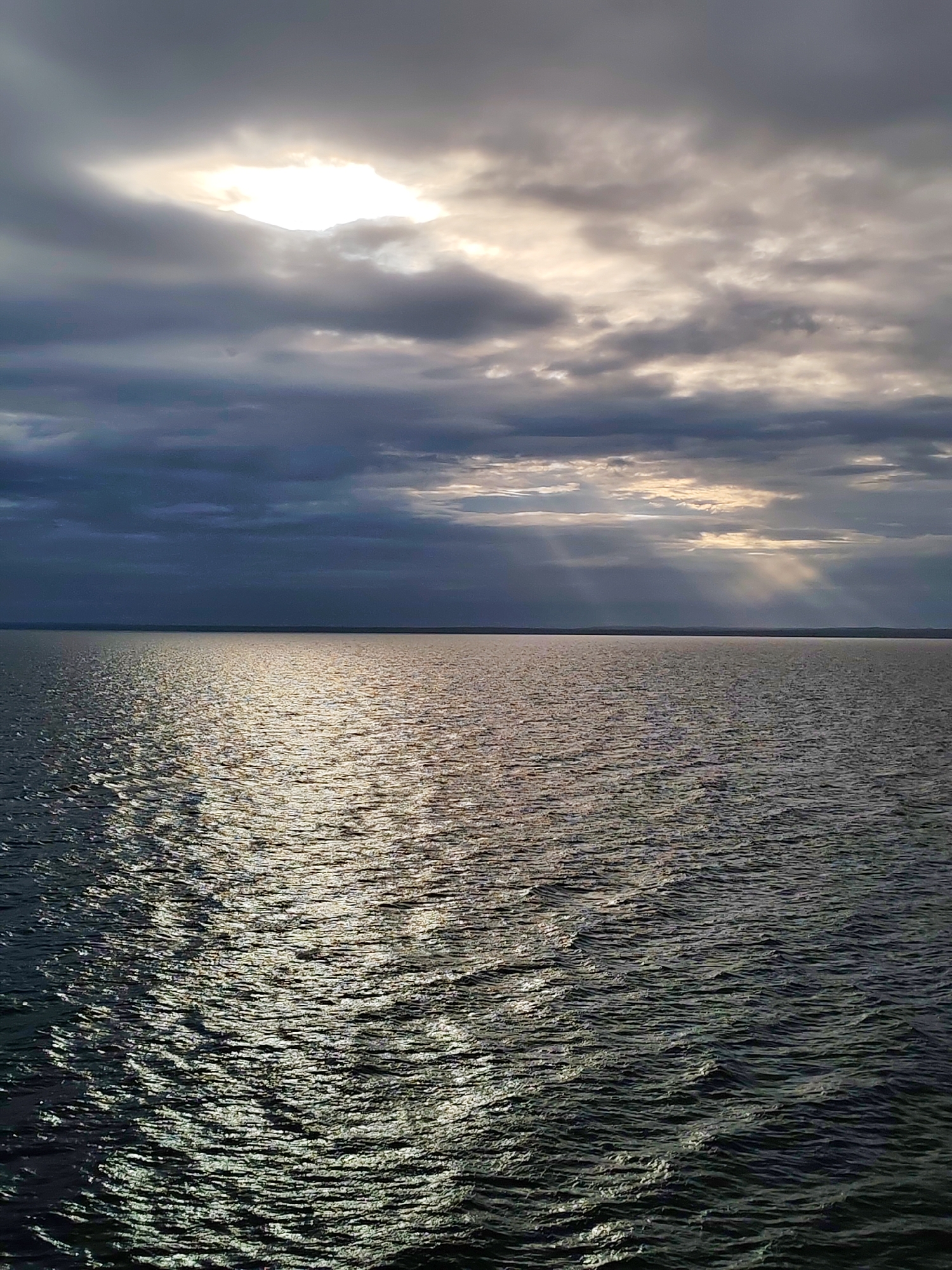 Dark storm clouds gather over water in Kuzaranda, Russia