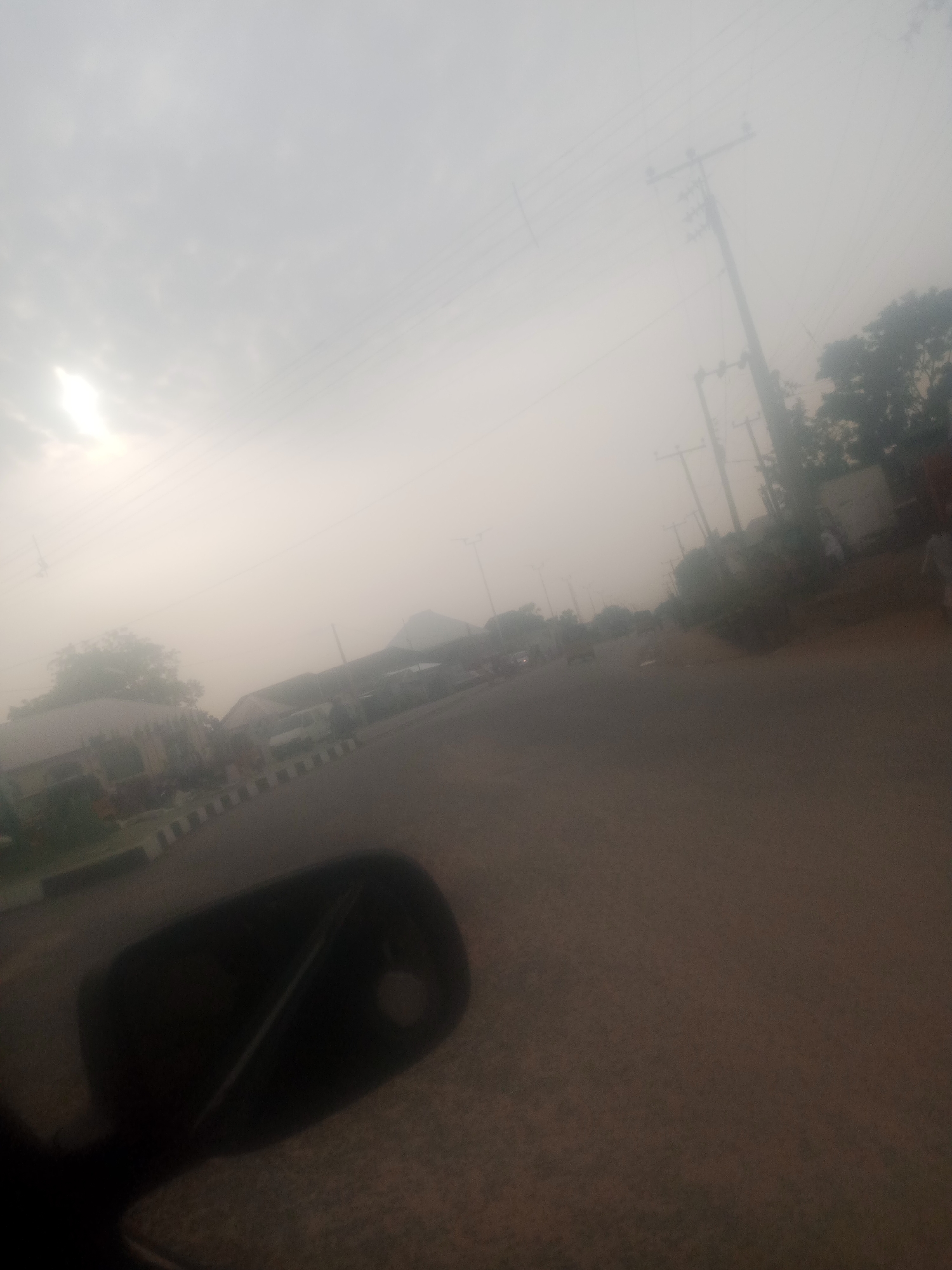Driving through hazy Jalingo streets, June 2026