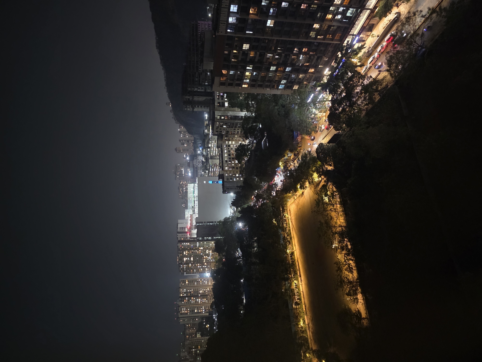 Aerial nighttime view captures Mumbai's illuminated high-rise skyline