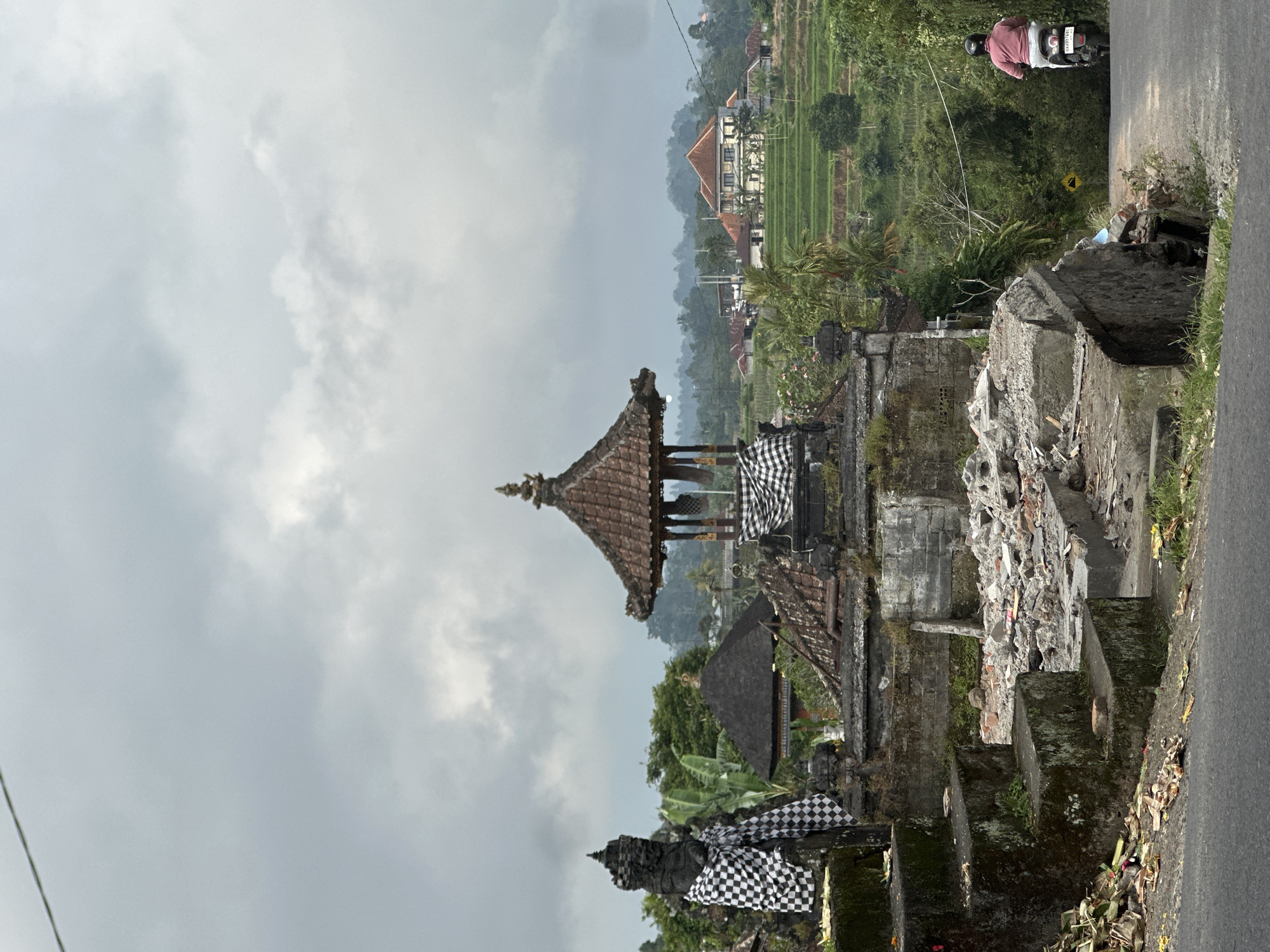 Traditional Balinese temple photographed under cloudy skies in Baturiti