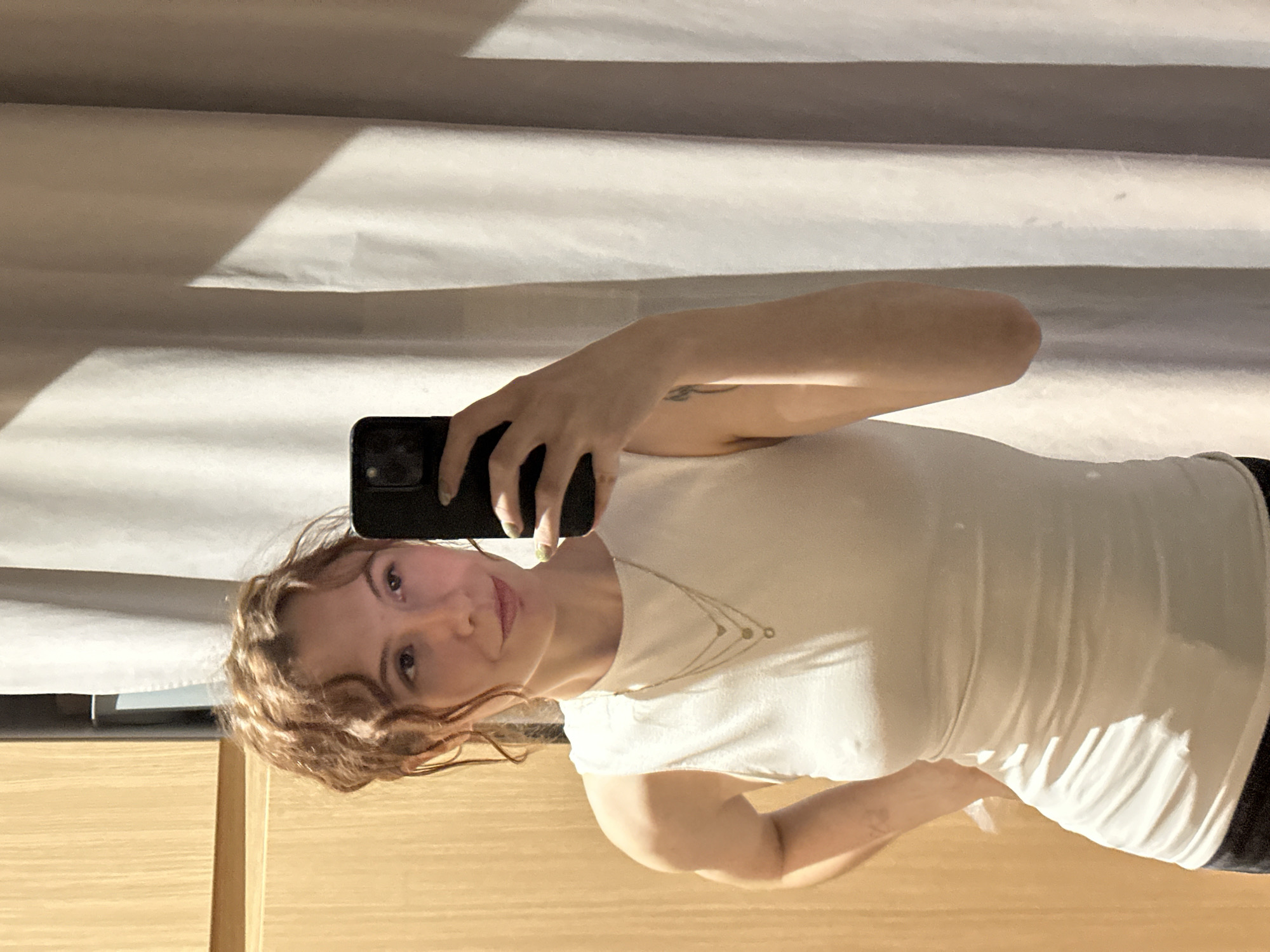 Woman takes mirror selfies indoors in Novi Sad
