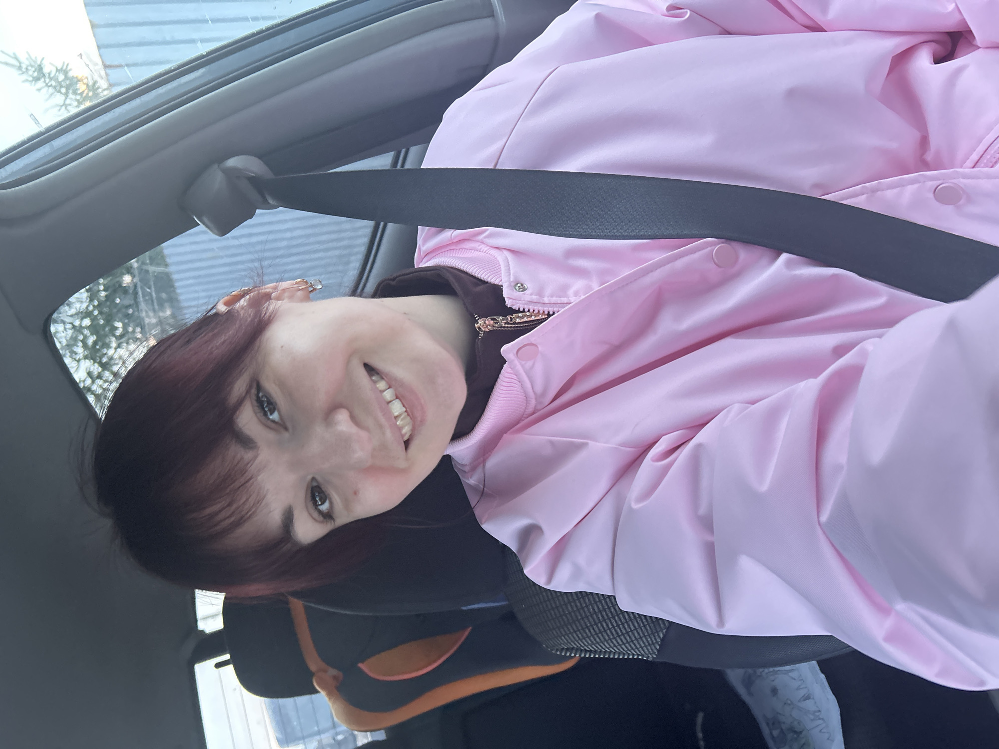 Woman with child car seat in parked vehicle