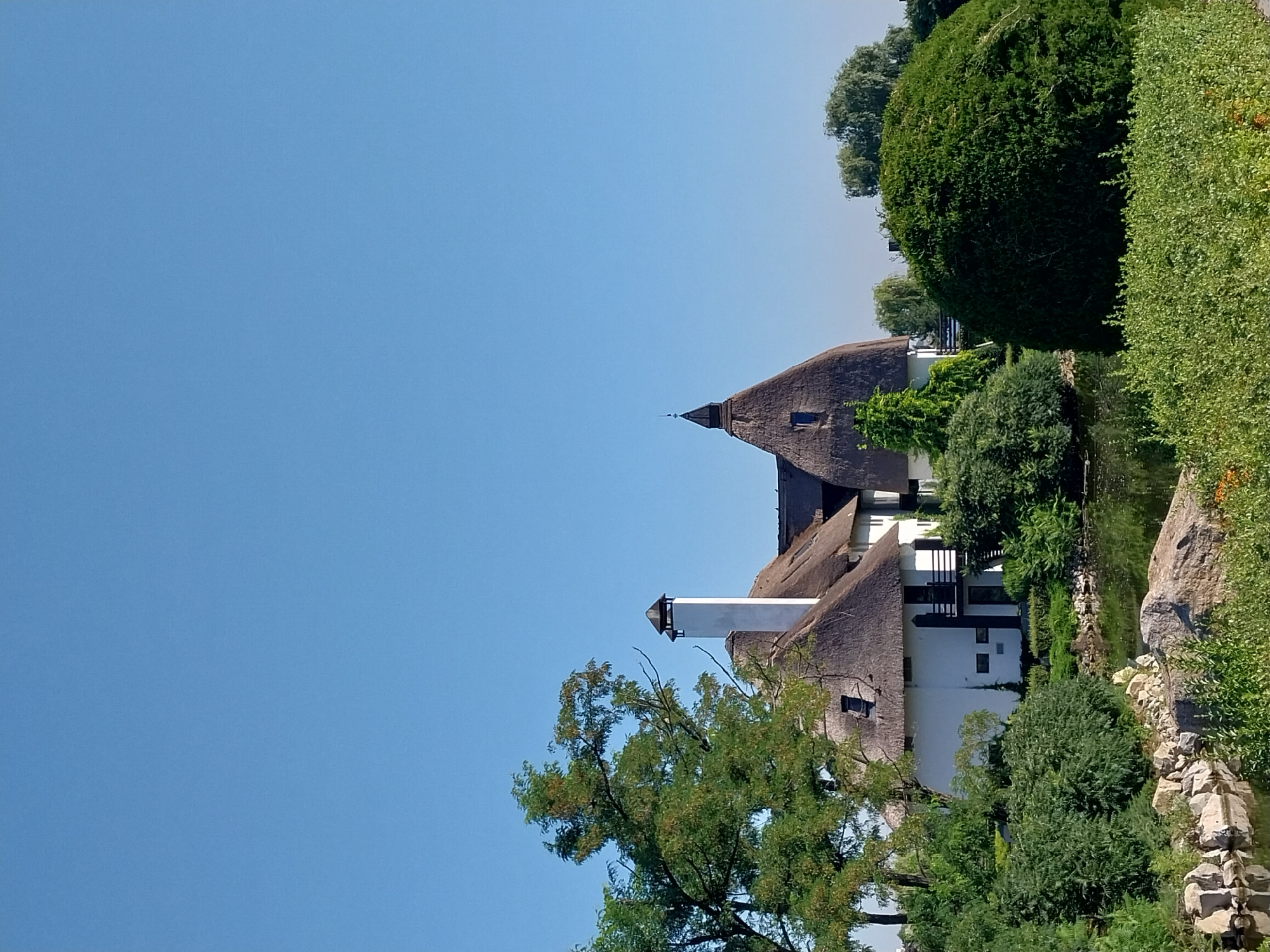 Morning walk through Dnipro's waterfront park and thatched-roof buildings