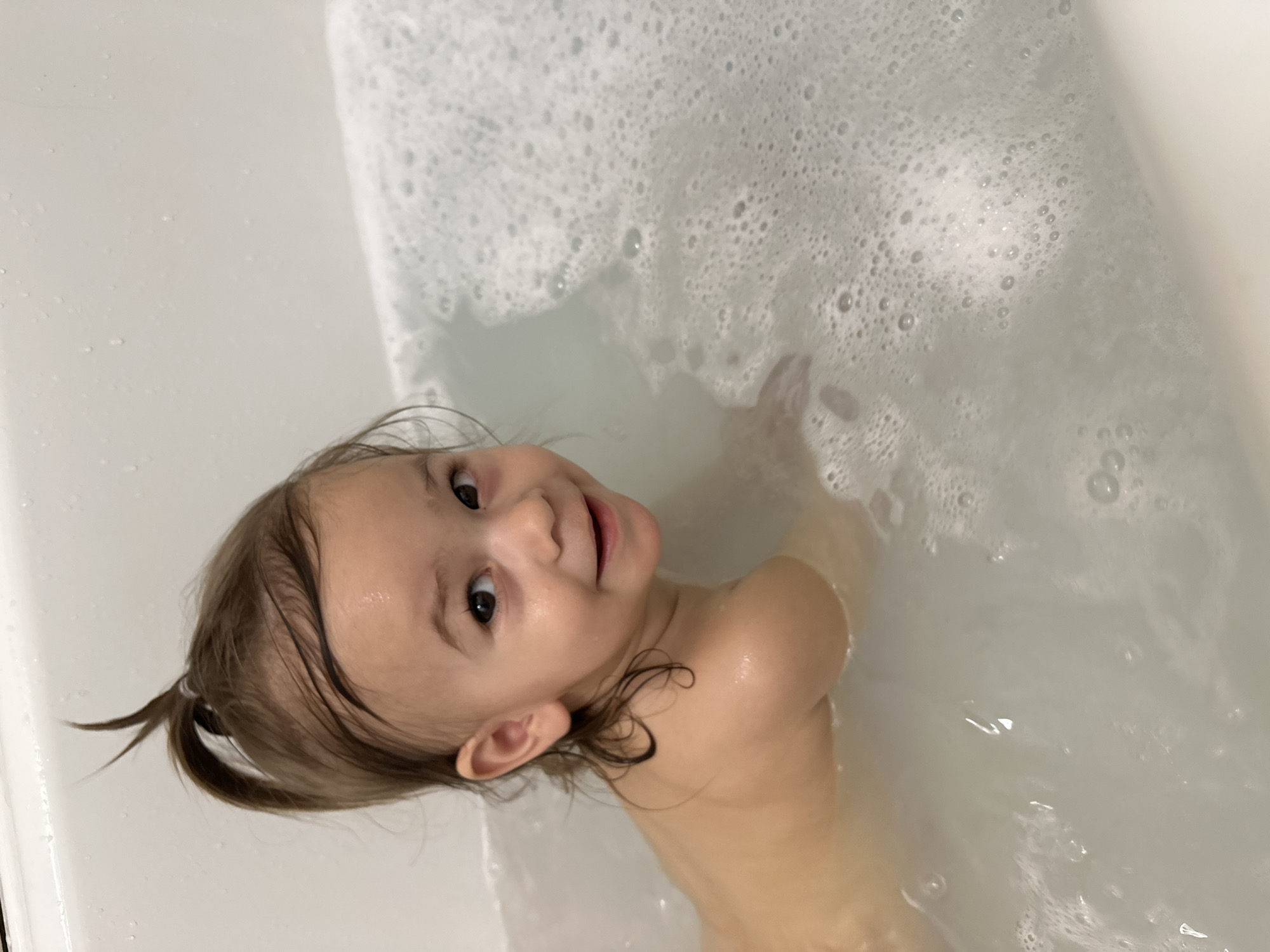 Child enjoys bubble bath in Kharnavy, Russia