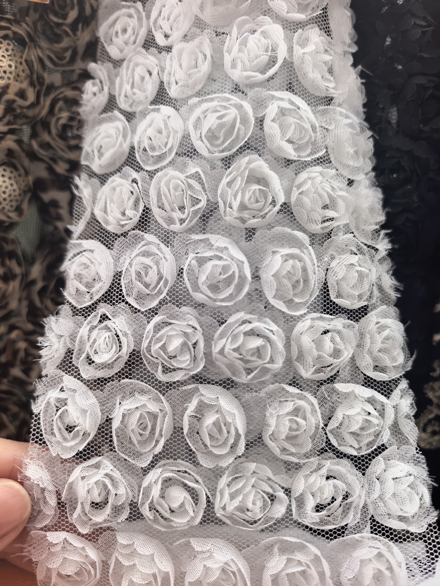 Shopper browses diverse fabric samples at Sterlitamak textile store