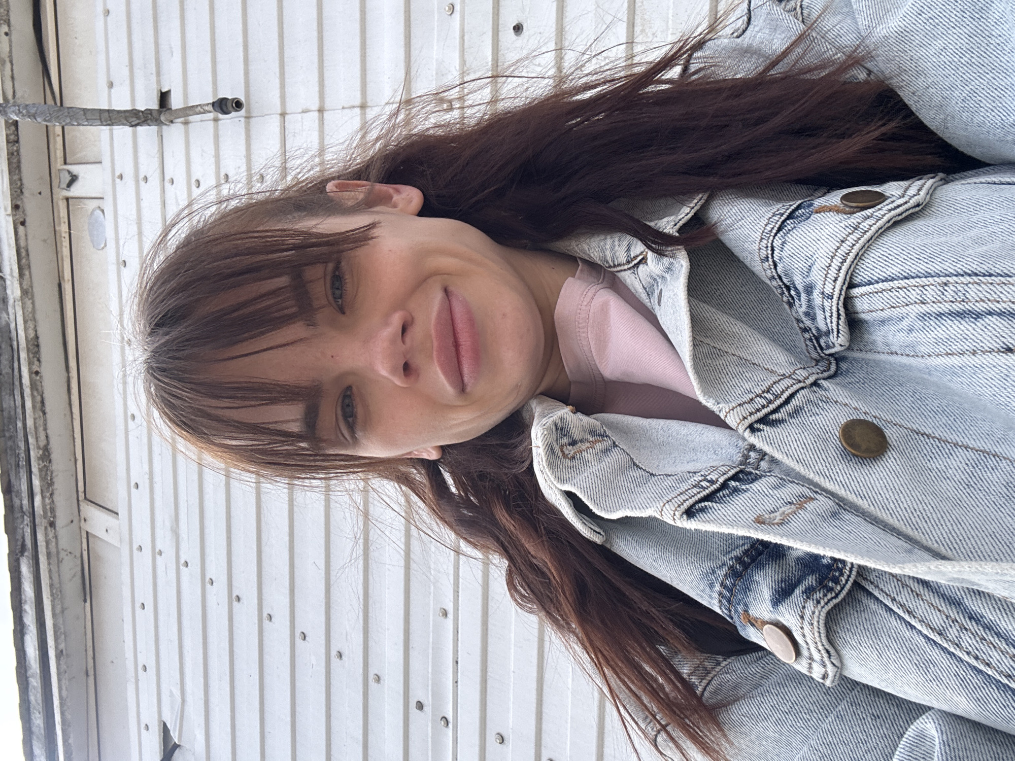 Woman in pink shirt, denim jacket photographed around Rostov-on-Don