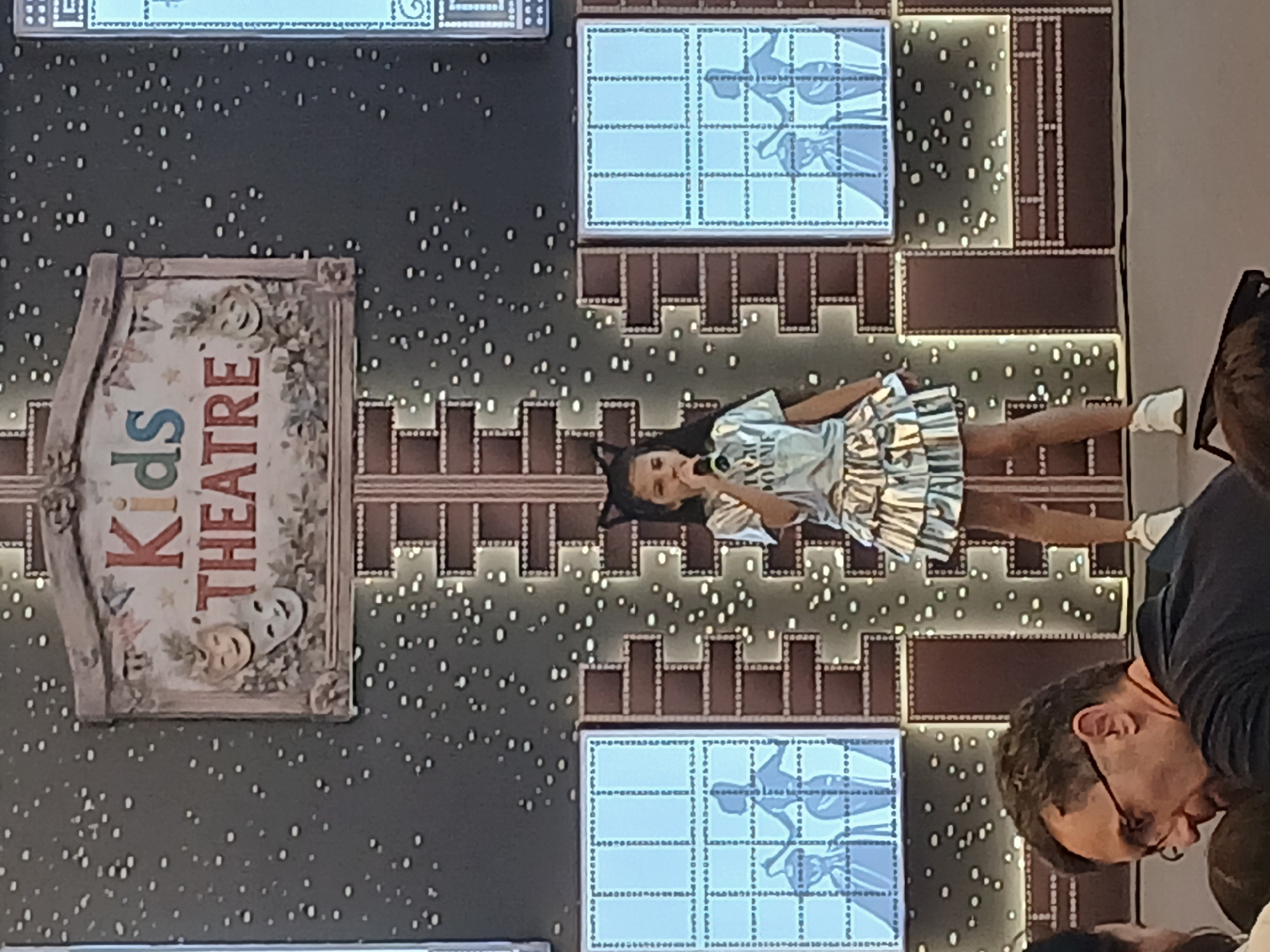 Kids singing competition at a themed stage venue