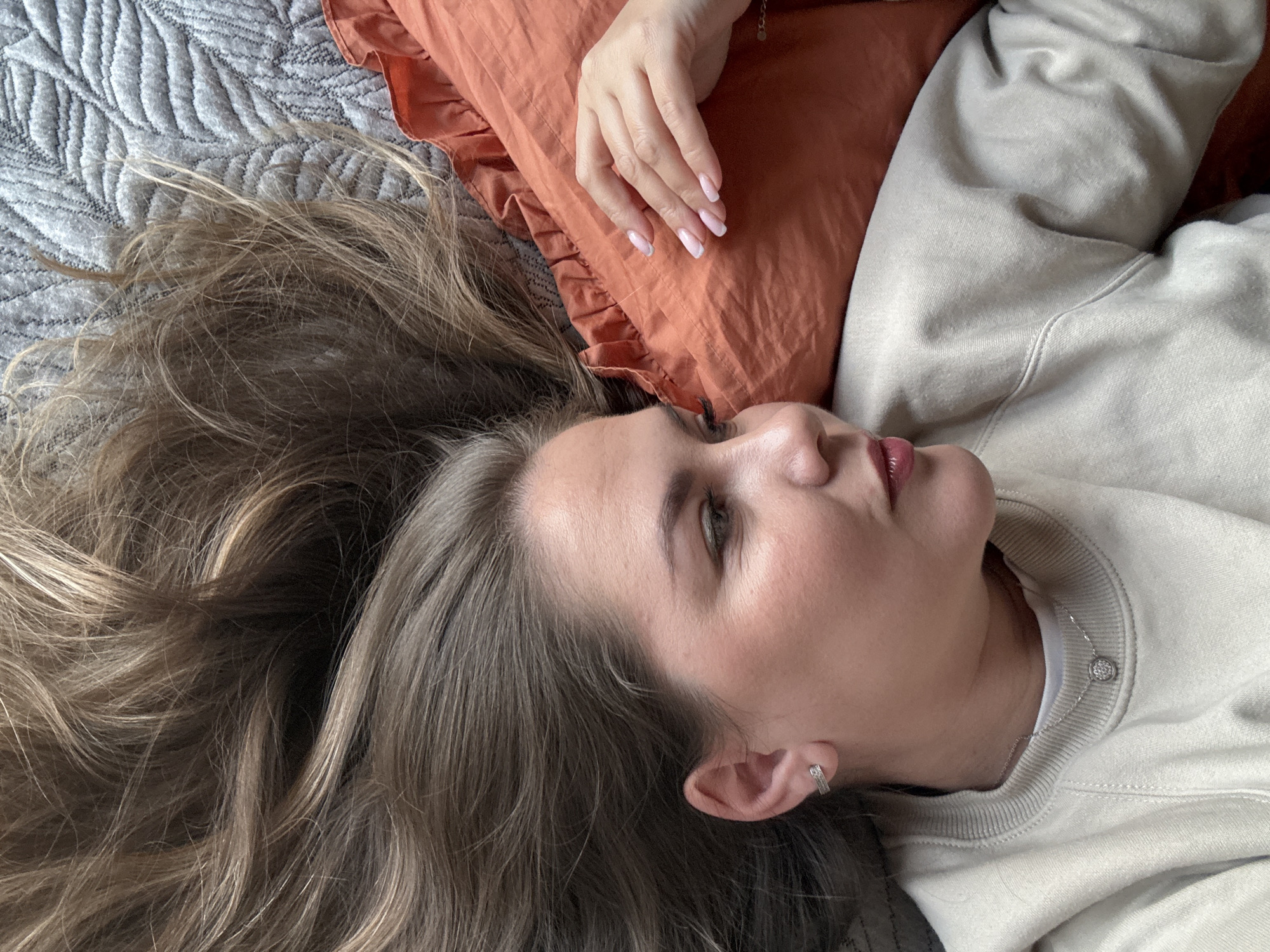 Woman resting on bed observed in Izhevsk, Russia