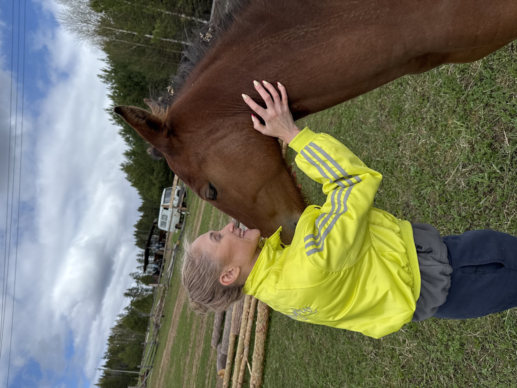 Woman pets horse in Russian field, shares moment