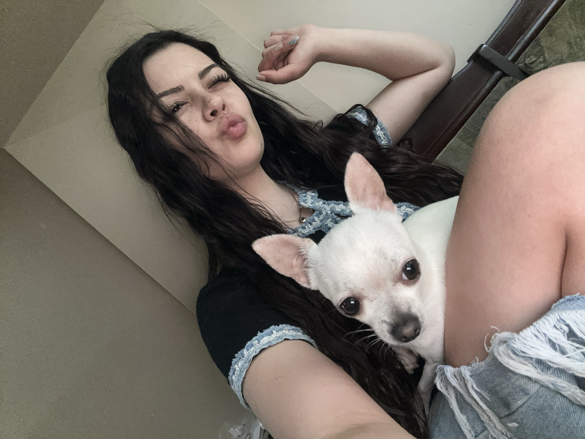 Woman takes selfies with white Chihuahua in Sliven