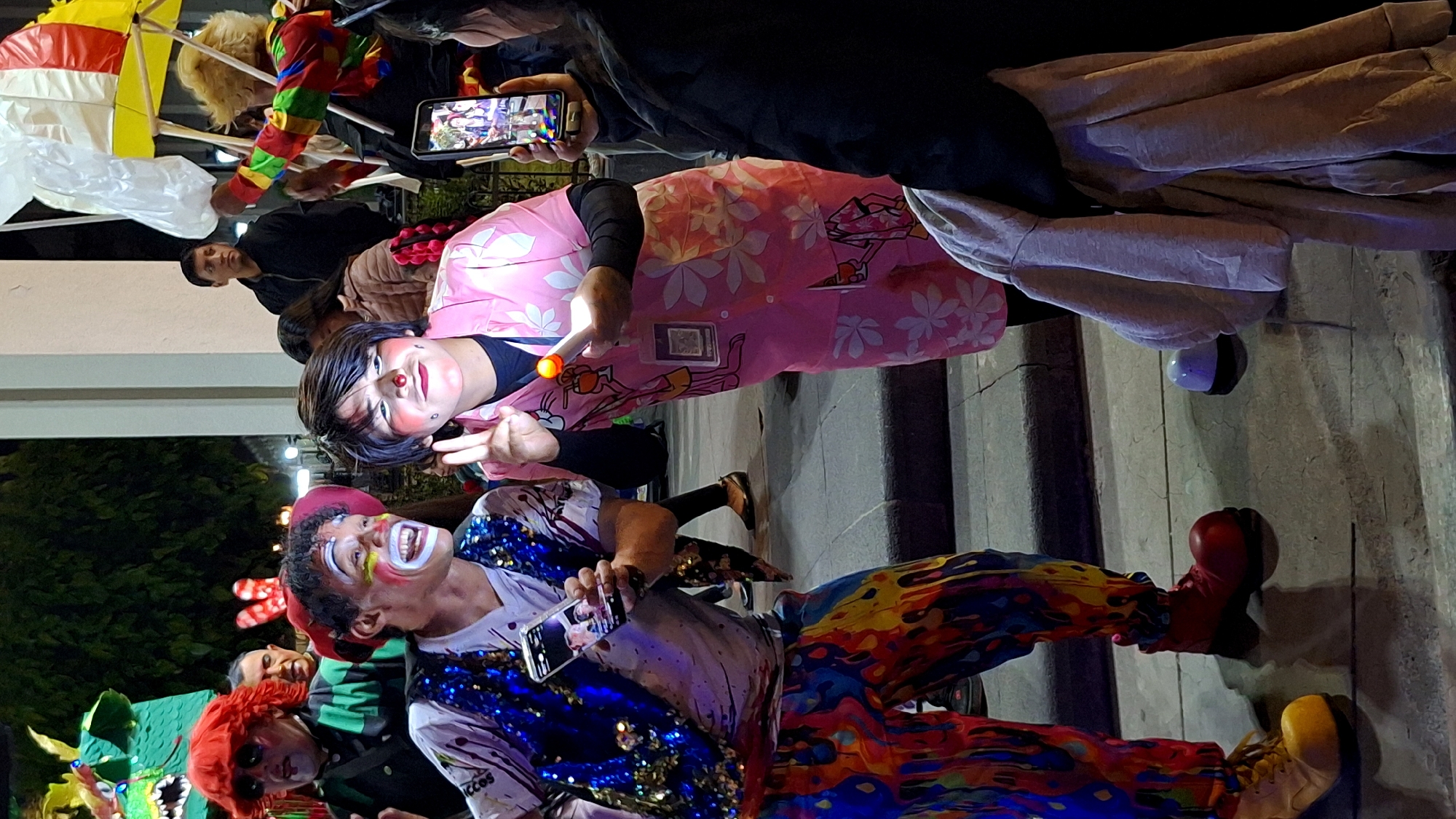 Clowns perform at nighttime street festival in Arequipa, Peru