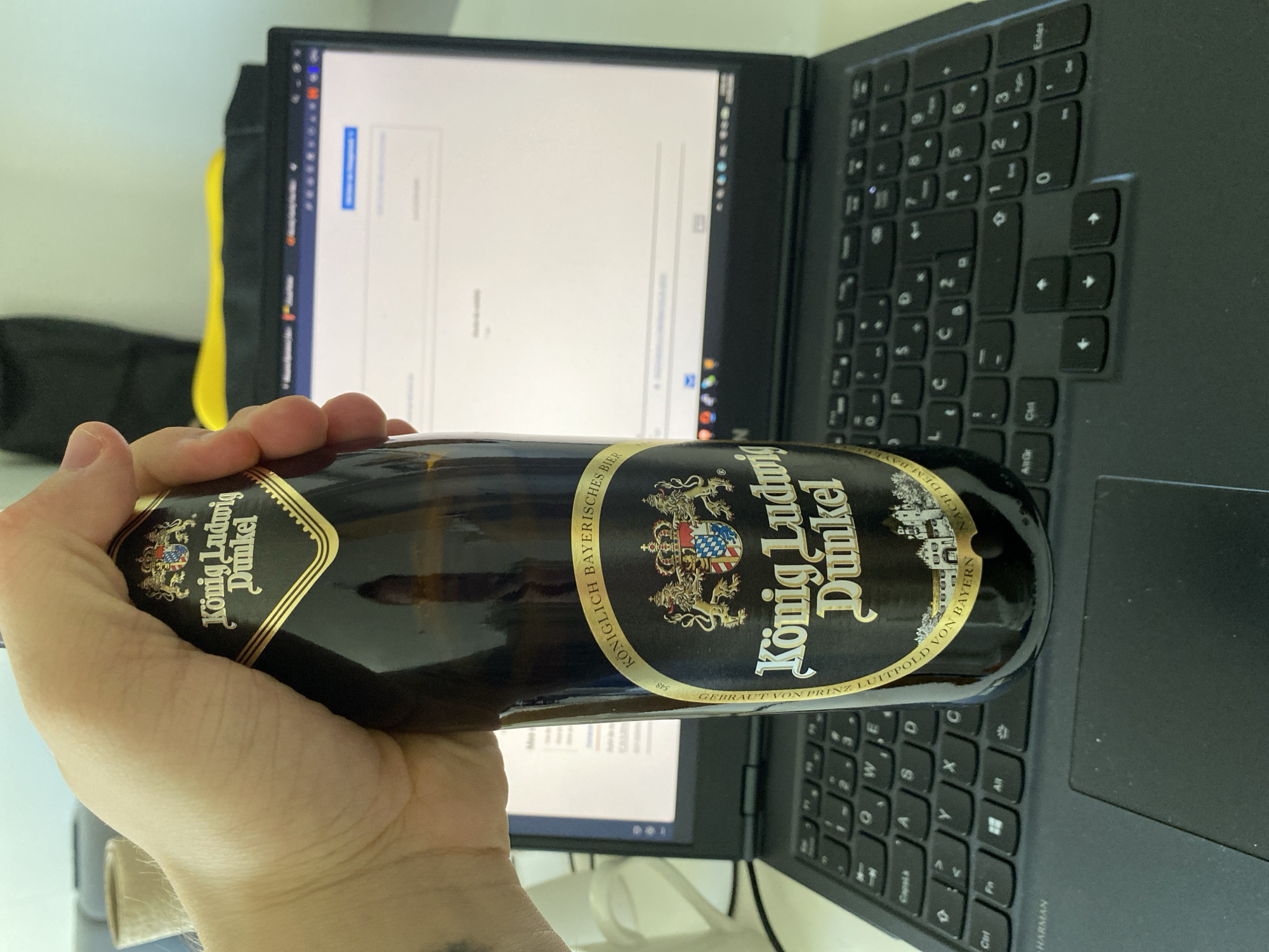 Berlin resident enjoys beer while working from home apartment