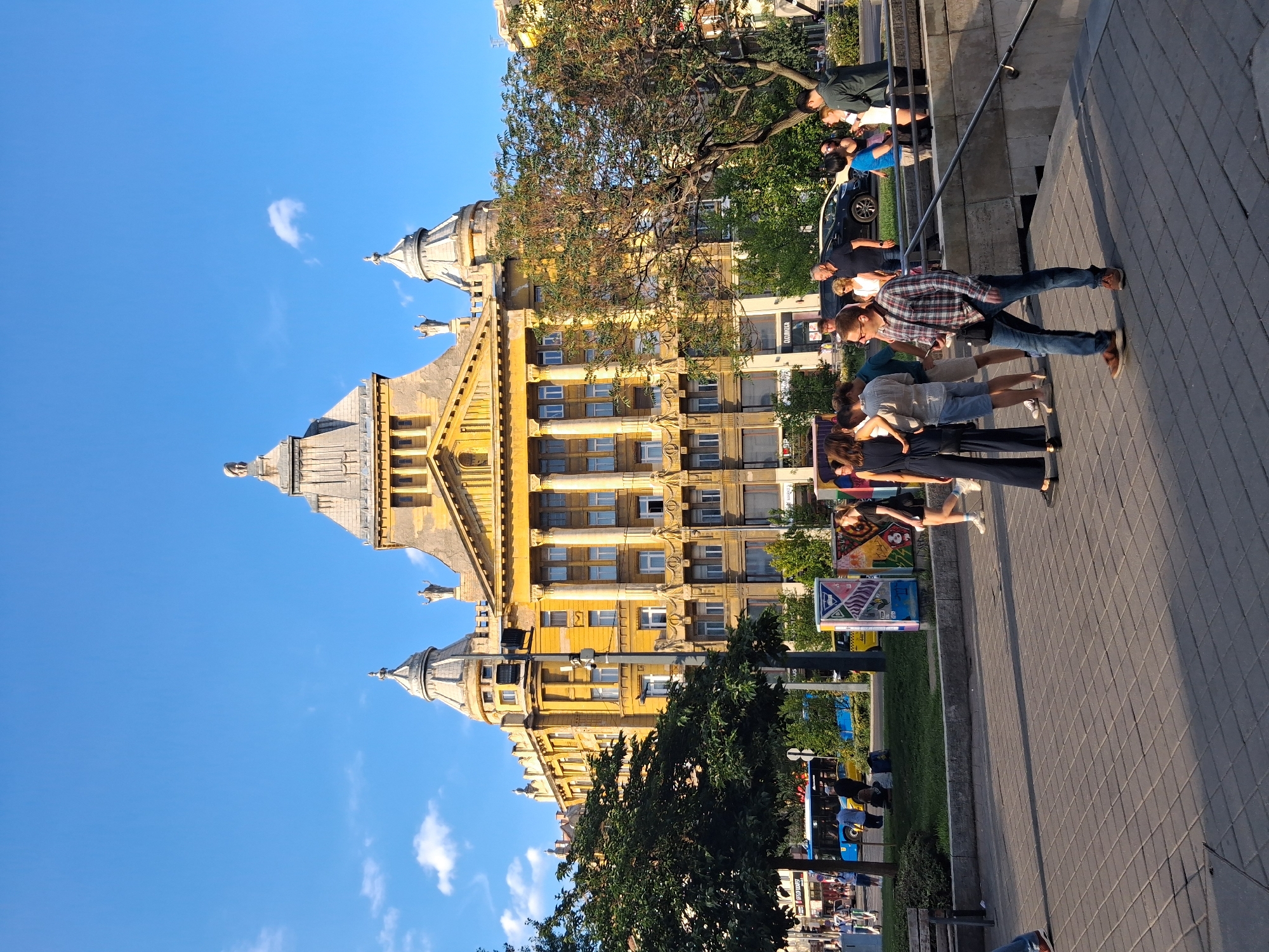 Classical yellow building with domed turrets on a Budapest street