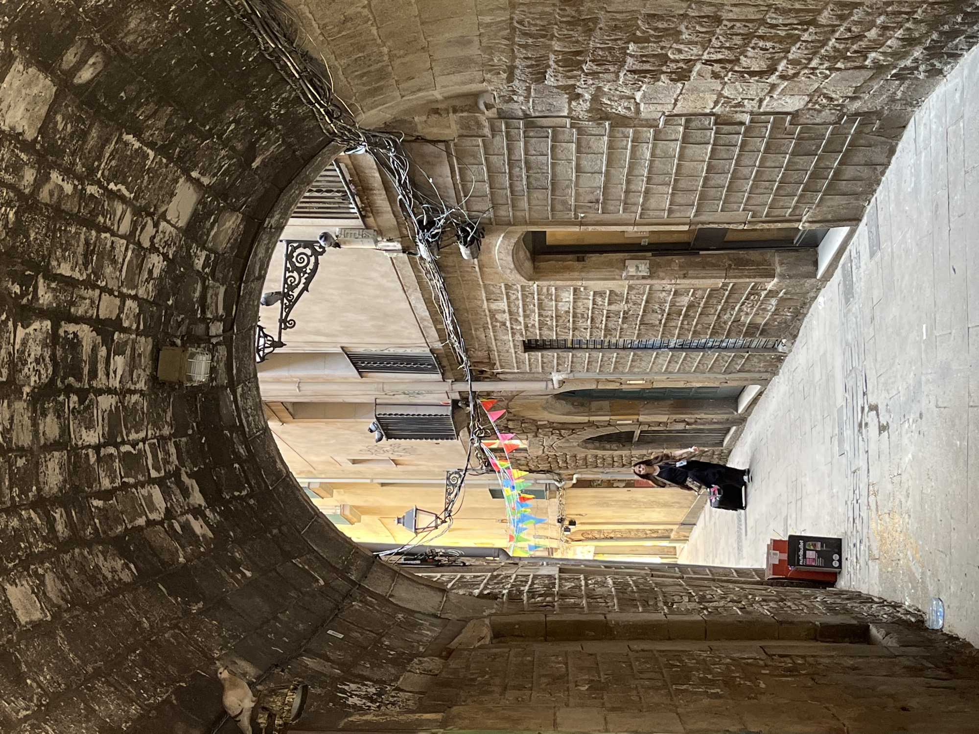 Tourist documents midday stroll through Barcelona's Gothic Quarter