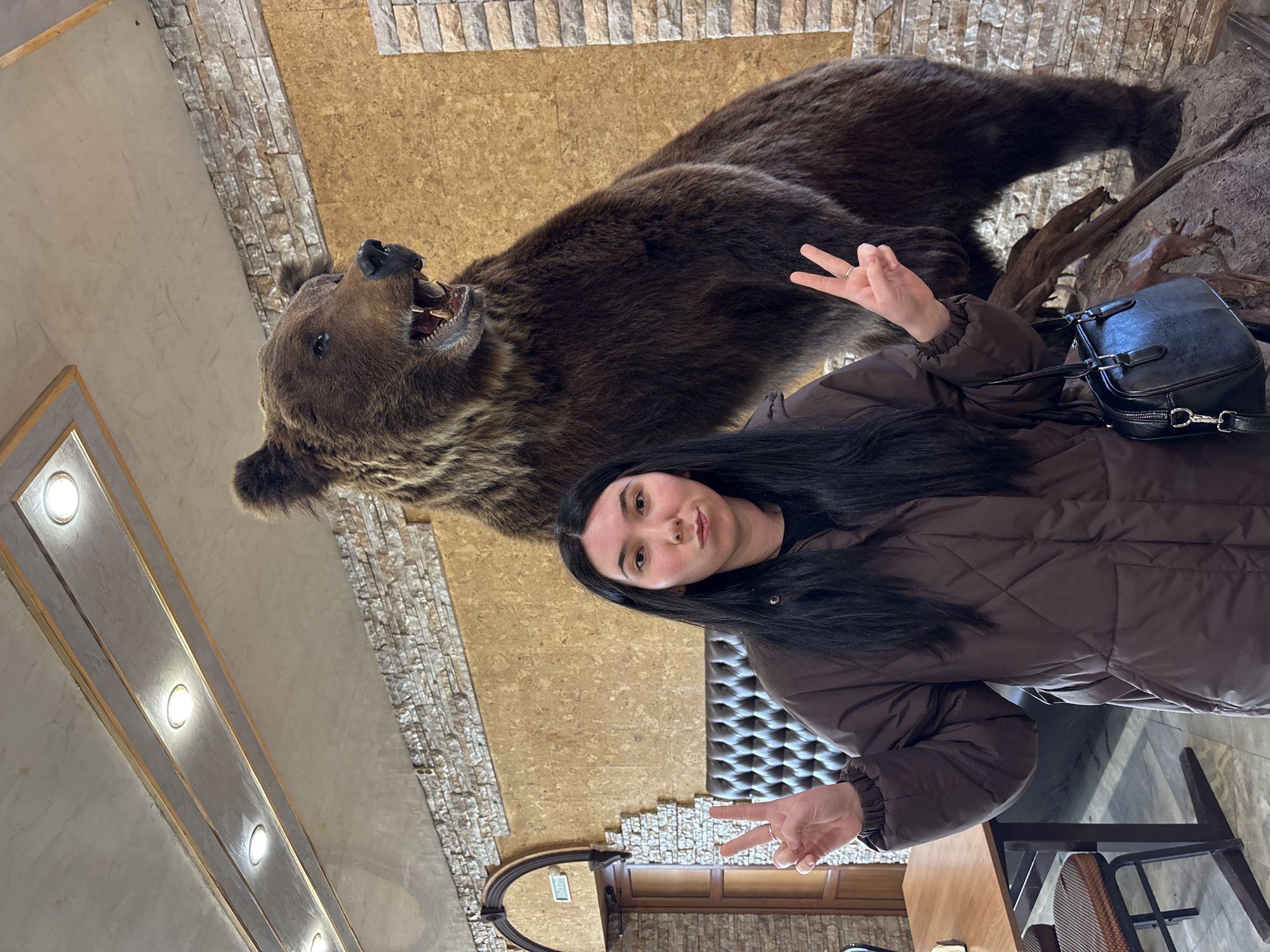 Woman photographed with taxidermied bear, plush toys in Mozhga