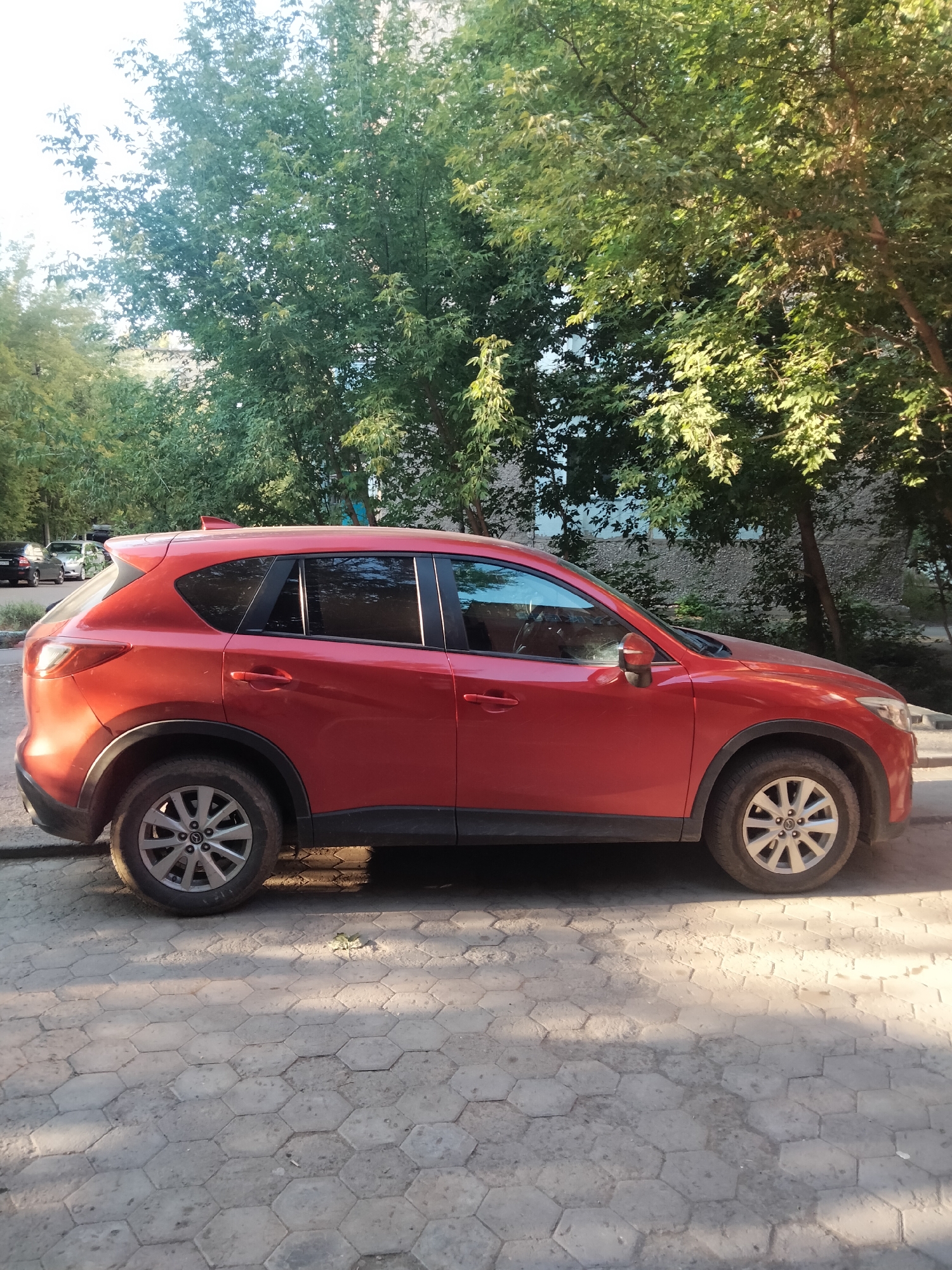 Two parked SUVs, side profiles, different surfaces
