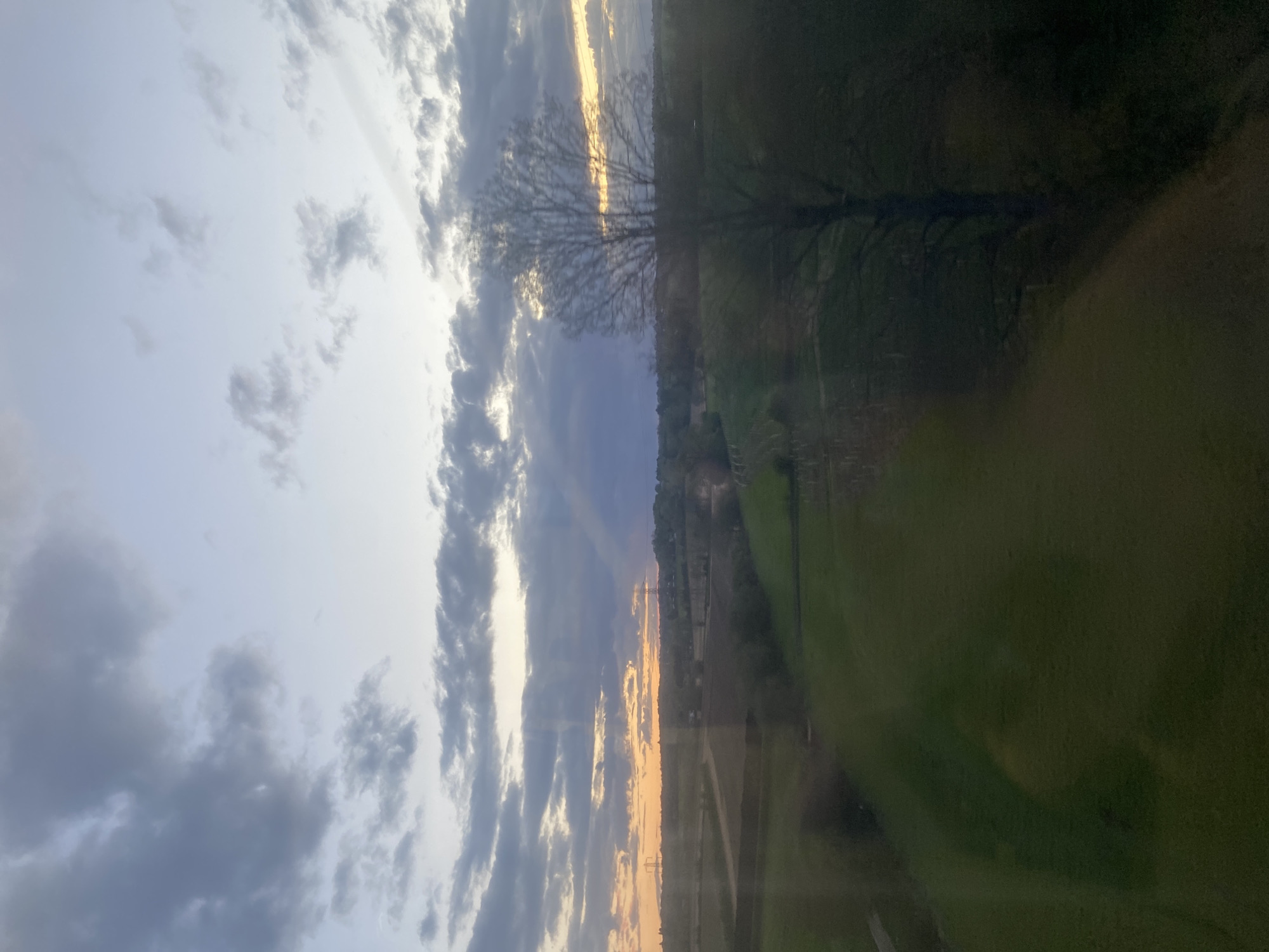 Sunset observed through window in London amid cloudy skies