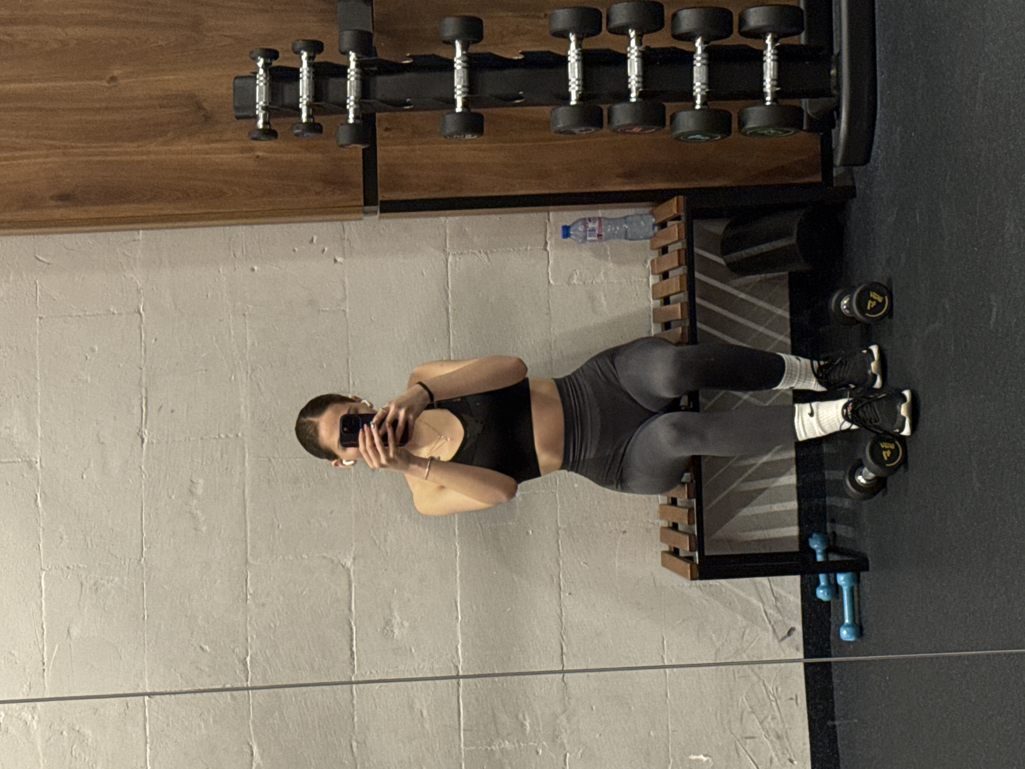 Woman takes mirror selfies during gym workout in Sofia