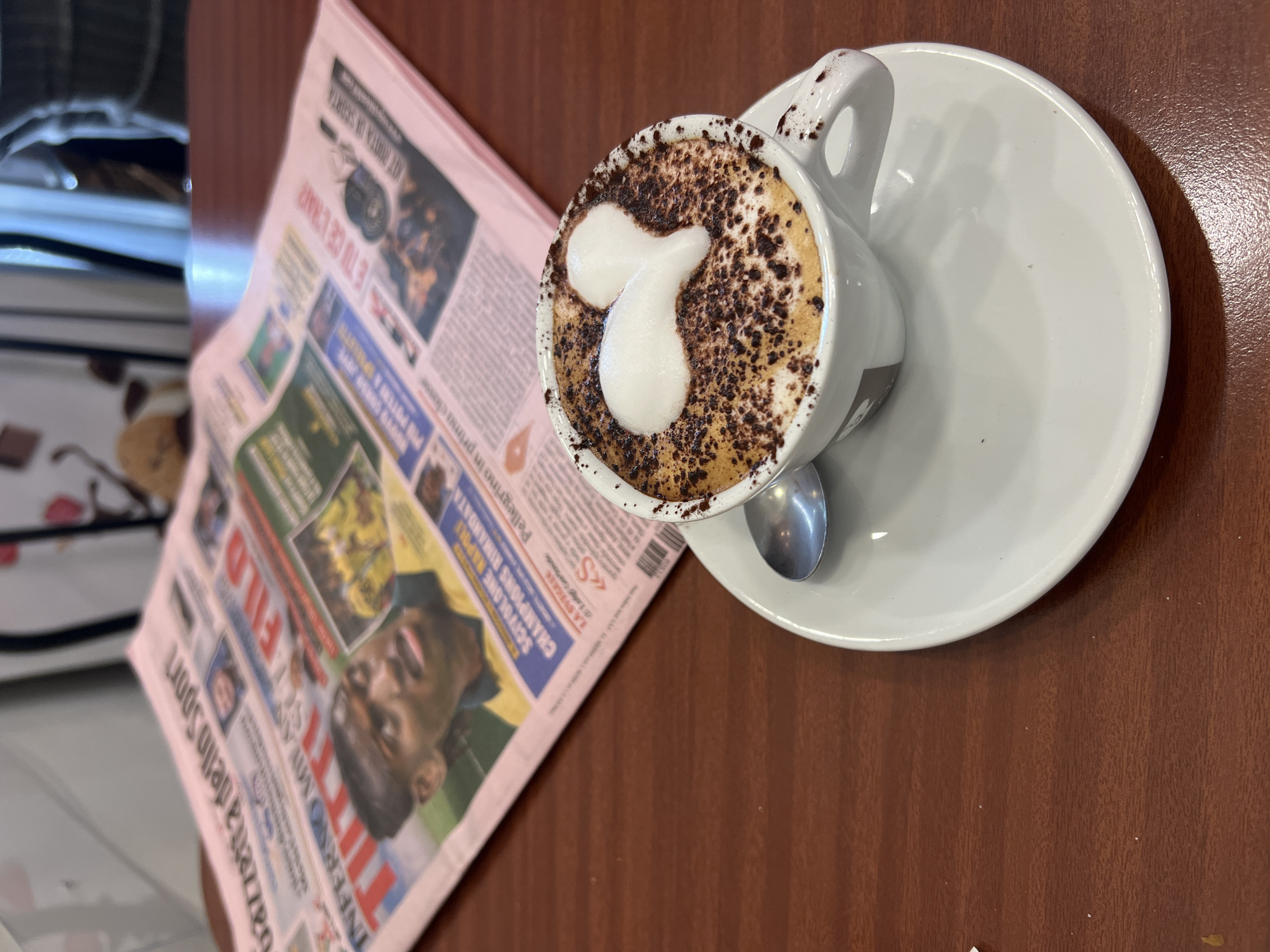 Morning cappuccino with foam art served in Milan cafe