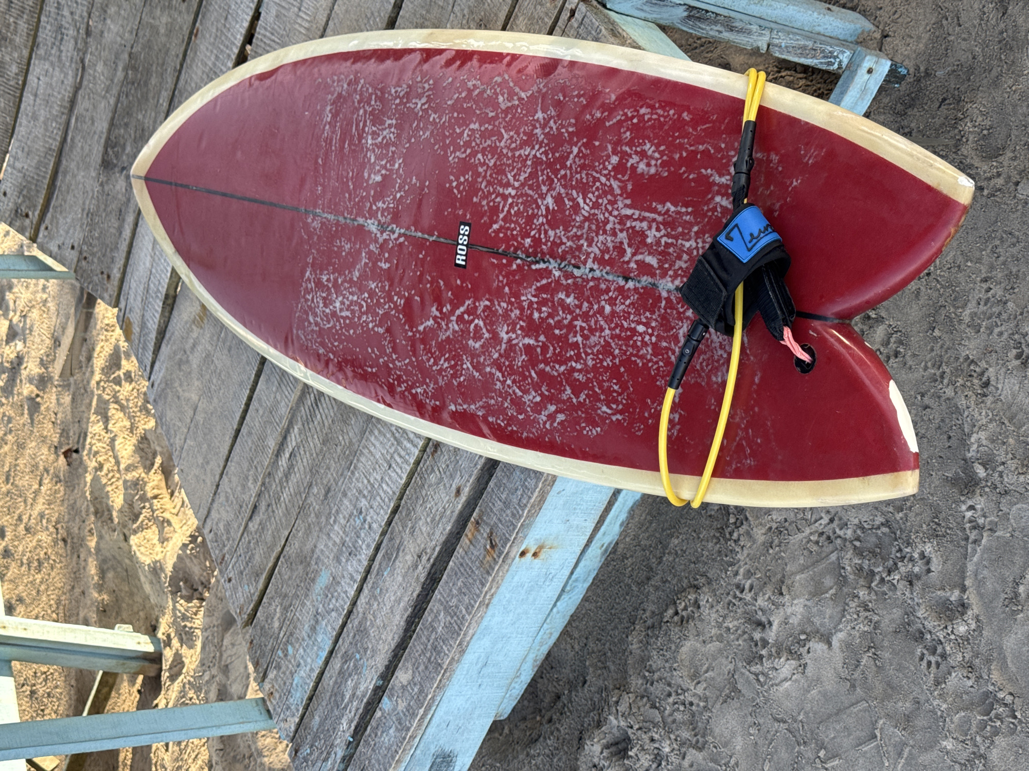 Red surfboard on a beach deck in Kathaluwa, Sri Lanka