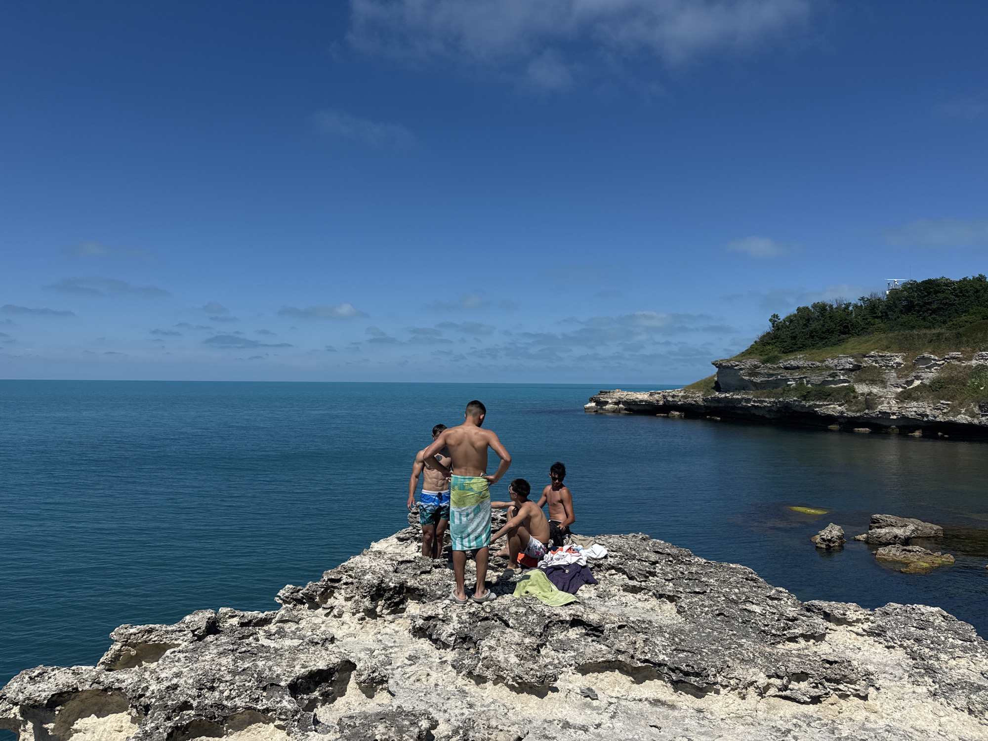 Young men enjoy cliff jumping, swimming at Tsarevo coastline