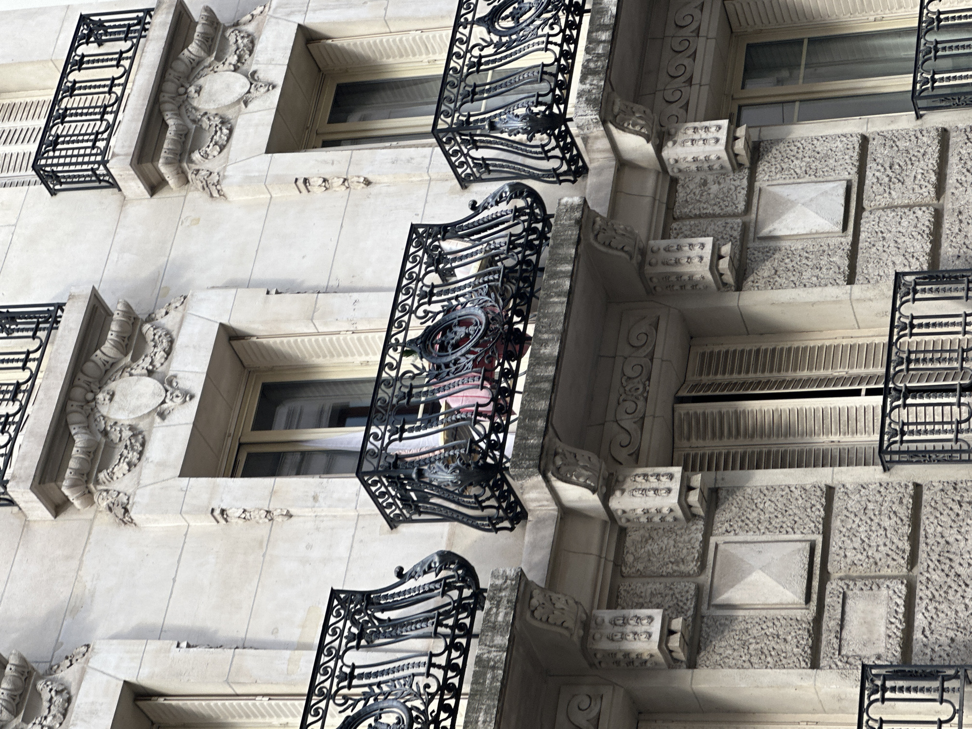 Close-up tour of Parisian building facades on a clear summer afternoon