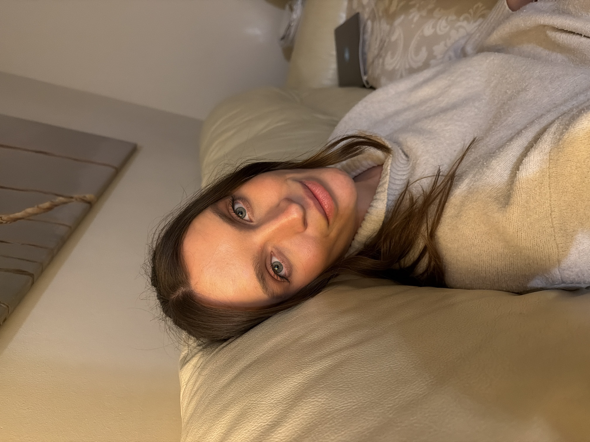 Woman rests on sofa indoors in Budva, Montenegro