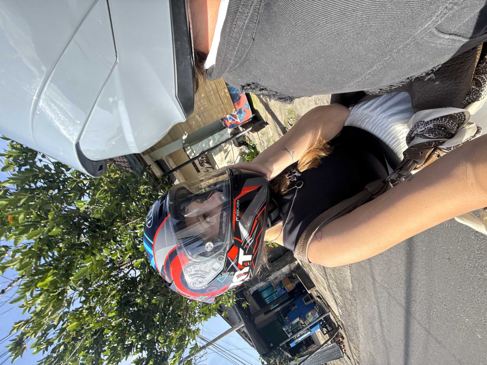 Motorcyclist travels through Blahbatuh village street during morning hours